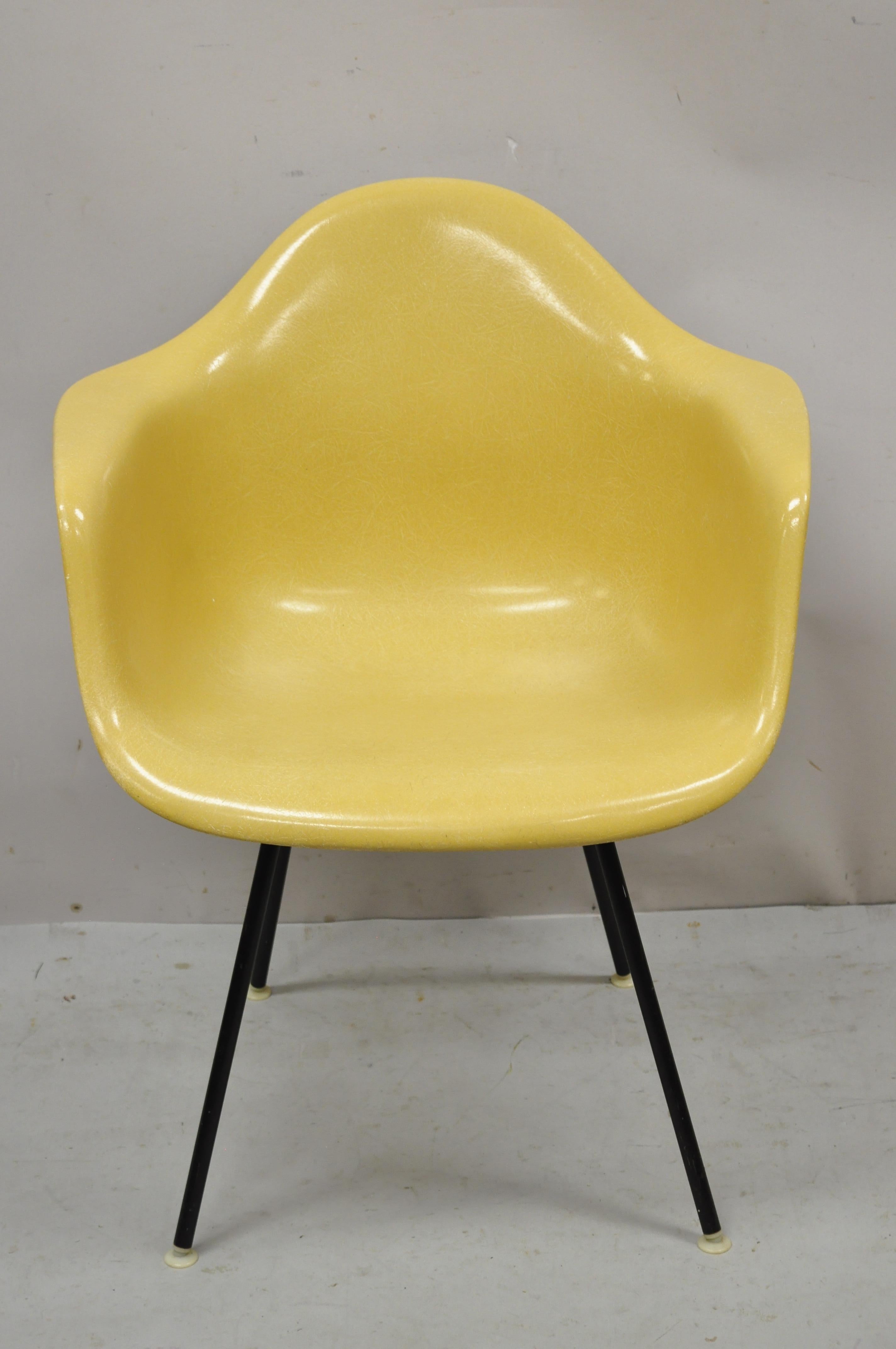 Herman Miller mustard yellow fiberglass shell H-Base arm chair. Item features 