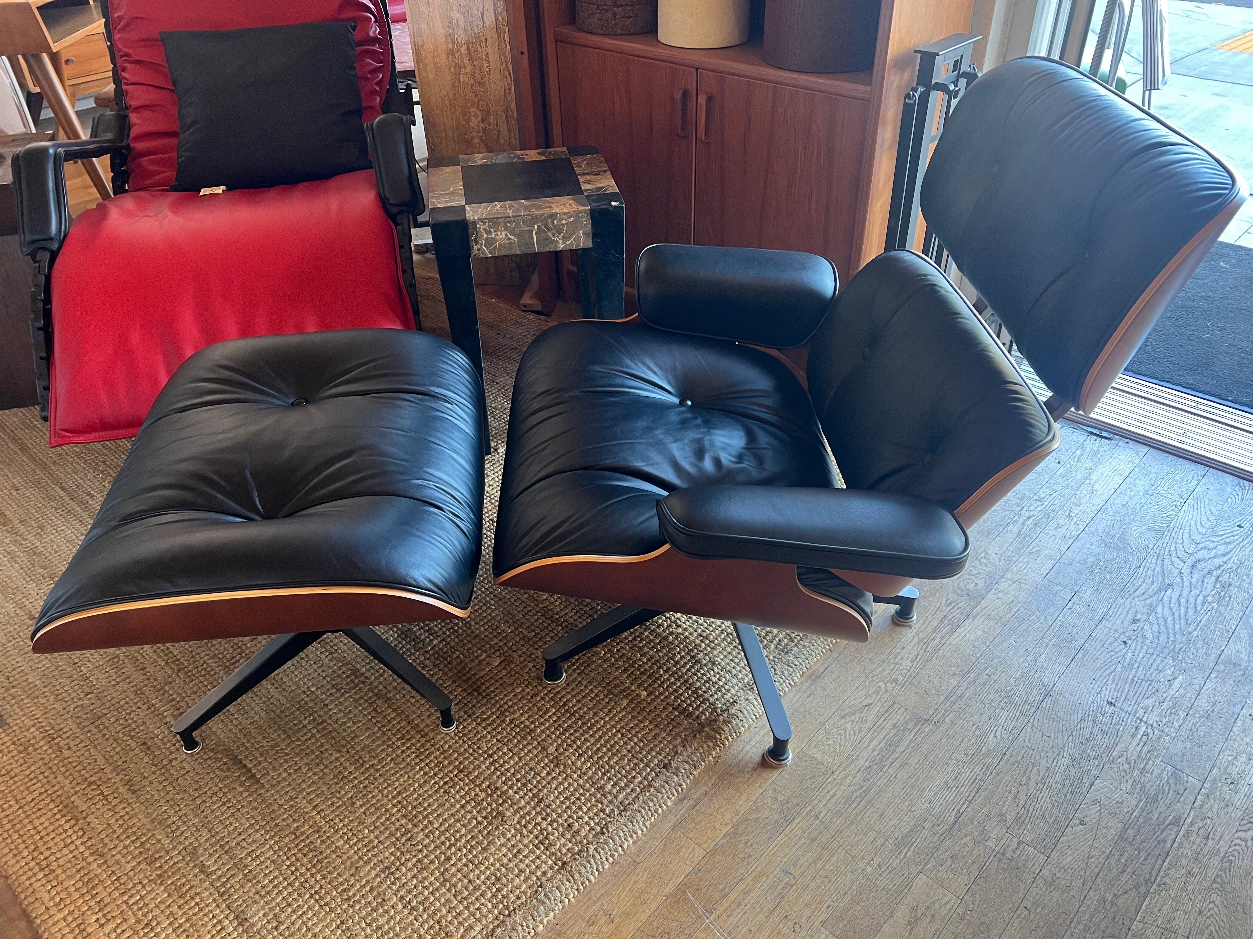 Authentic Charles Eames lounge chair and ottoman by Herman Miller, Cherry and black Leather. great condition . from 1999 very light use discontinued wood finish priced to sell solid sturdy with labels.