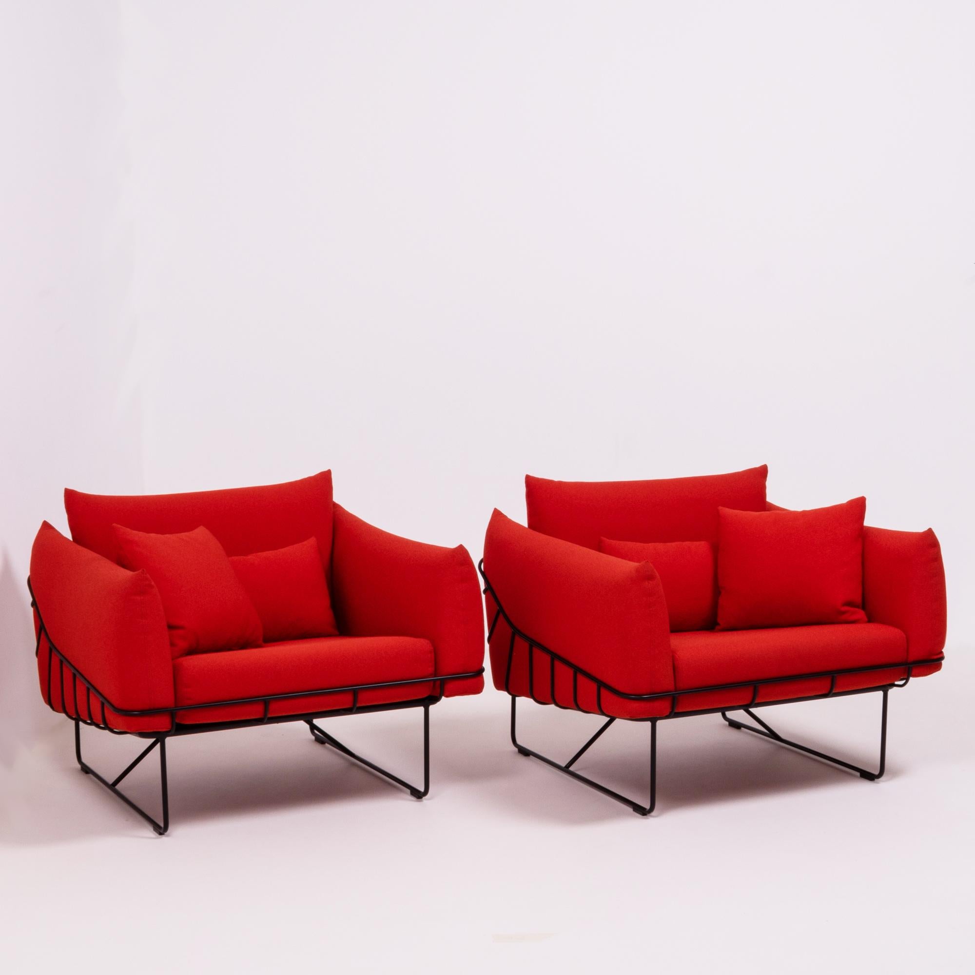 Designed by Sam Hecht and Kim Colin for Herman Miller, this set of Wireframe lounge chairs is bold and contemporary.

The structural black steel wire frame is contrasted by the soft upholstery in a bright red fabric.

Each chair has a separate
