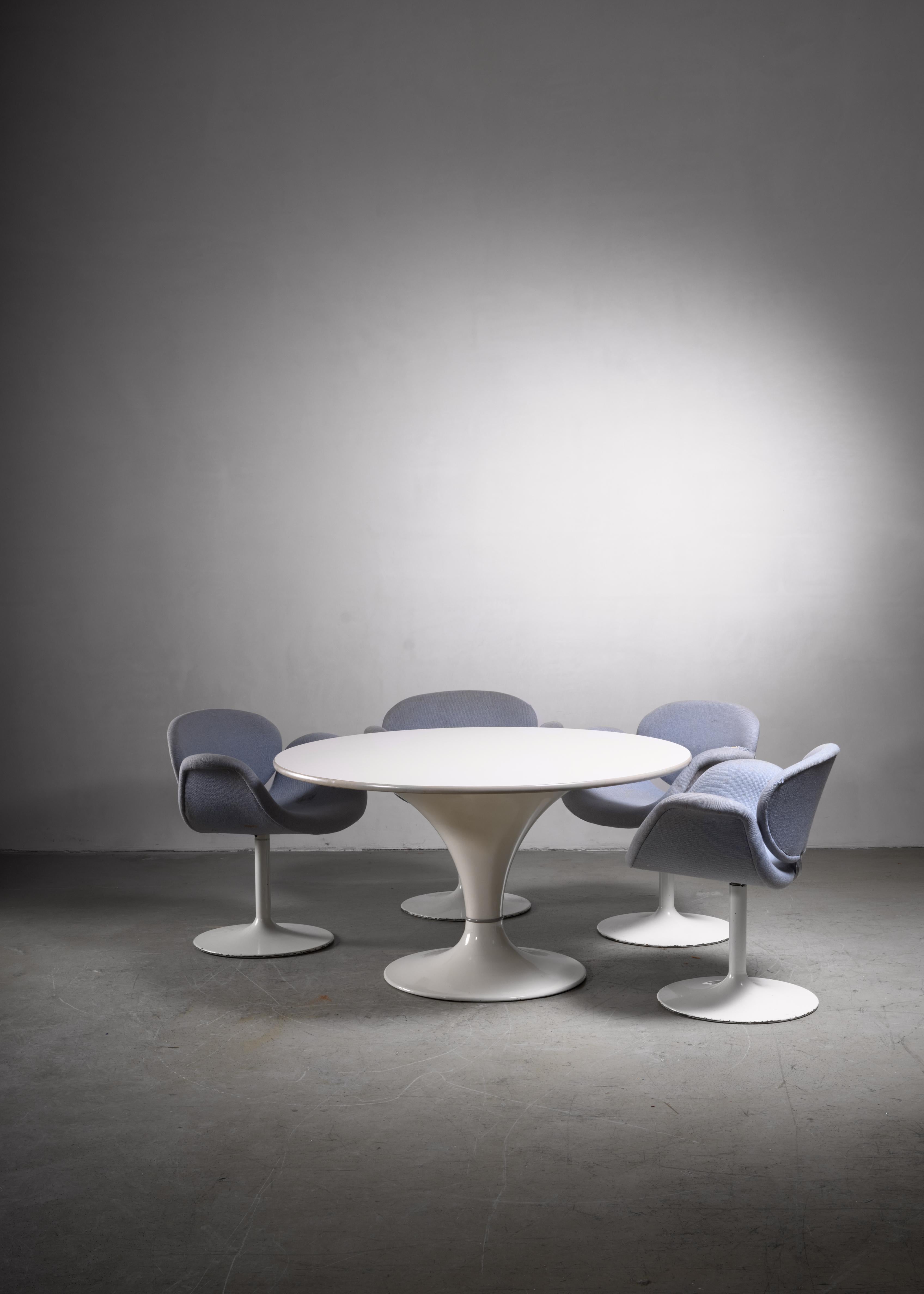 A mid-century Herman Miller dining table with a round top on a conical base. The base is made of a white enameled metal base and a wood with formica top. Labeled by Herman Miller and in a very good condition.

 