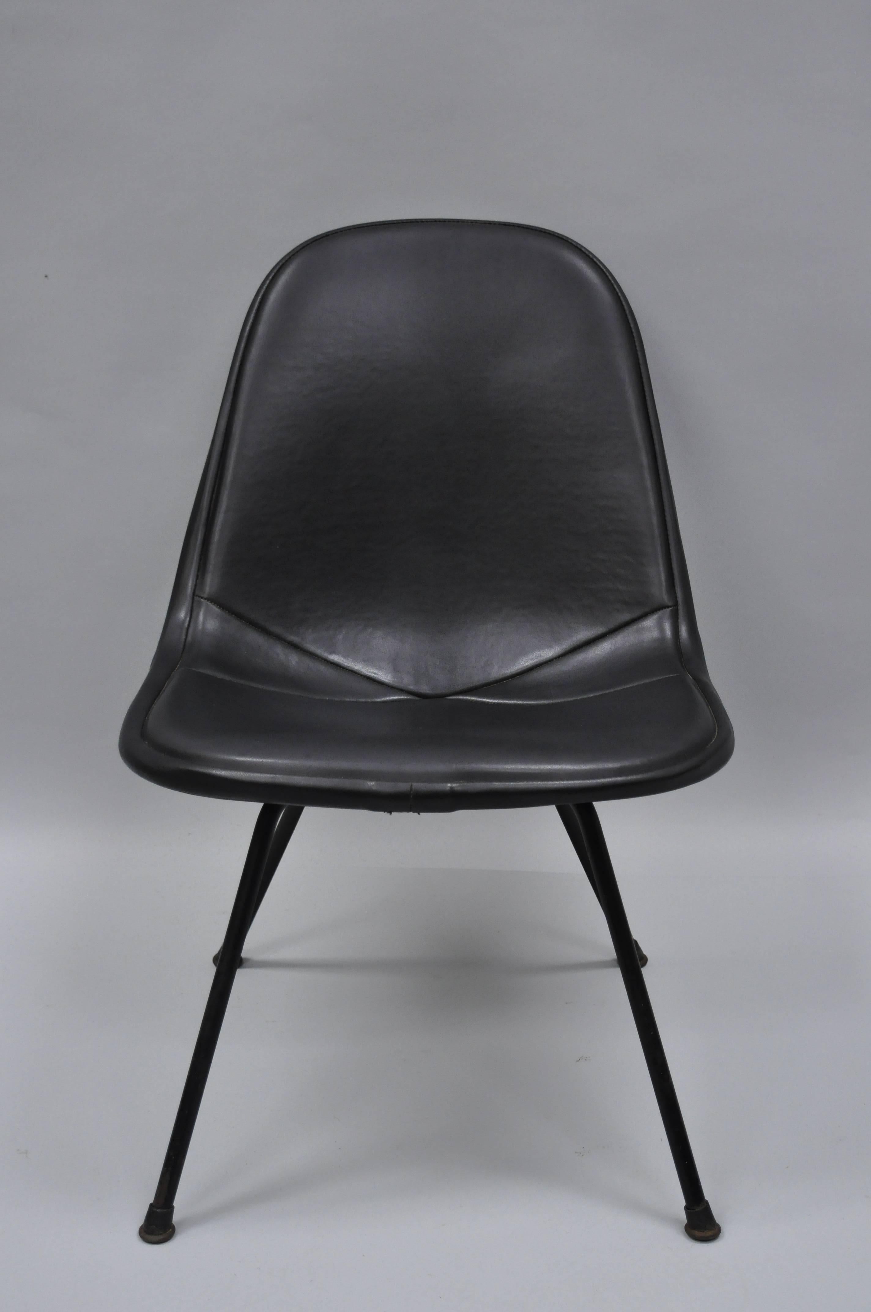 Vintage Eames upholstered DKX wire frame chair for Herman Miller on its original low black base. Item features believed to be an original 1st edition vinyl upholstered DKX chair on its original low ‘X’ base. Herman Miller tag to underside, circa