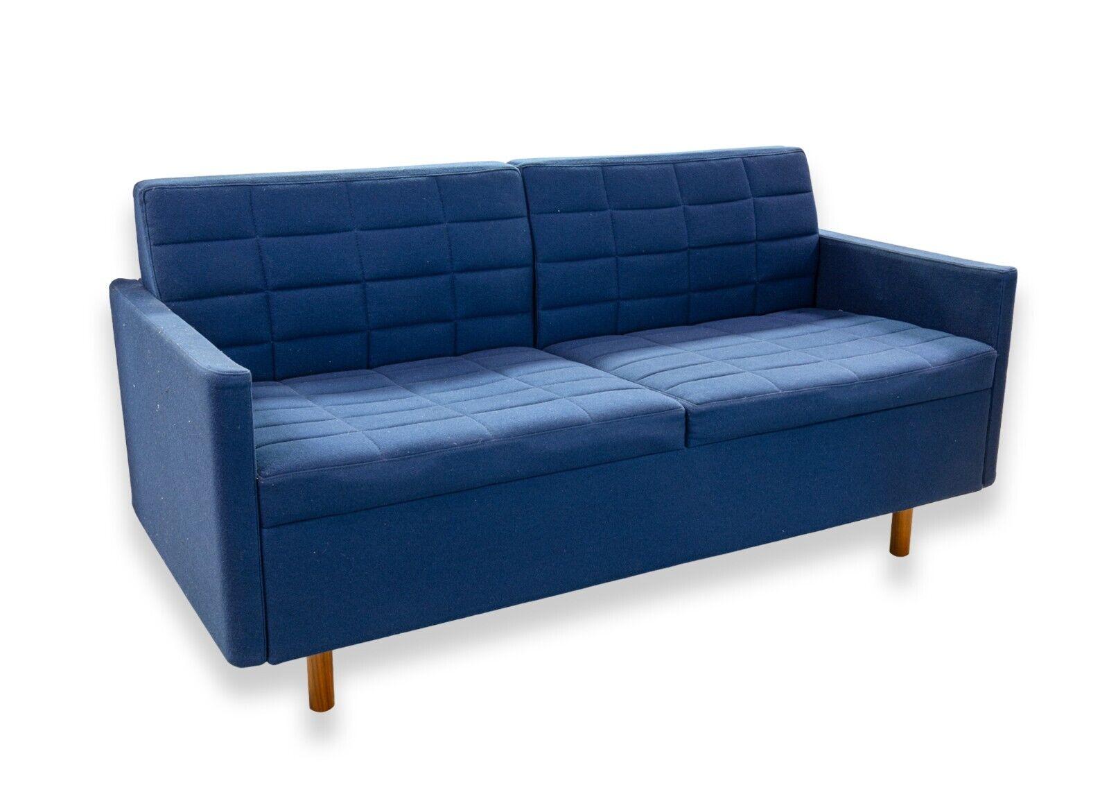 A Herman Miller x Geiger International Tuxedo Classic Blue Settee Loveseat. This is a gorgeous contemporary loveseat from a collaboration of Herman Miller and Geiger International. This lovely sofa features a lush, deep blue tufted upholstery made
