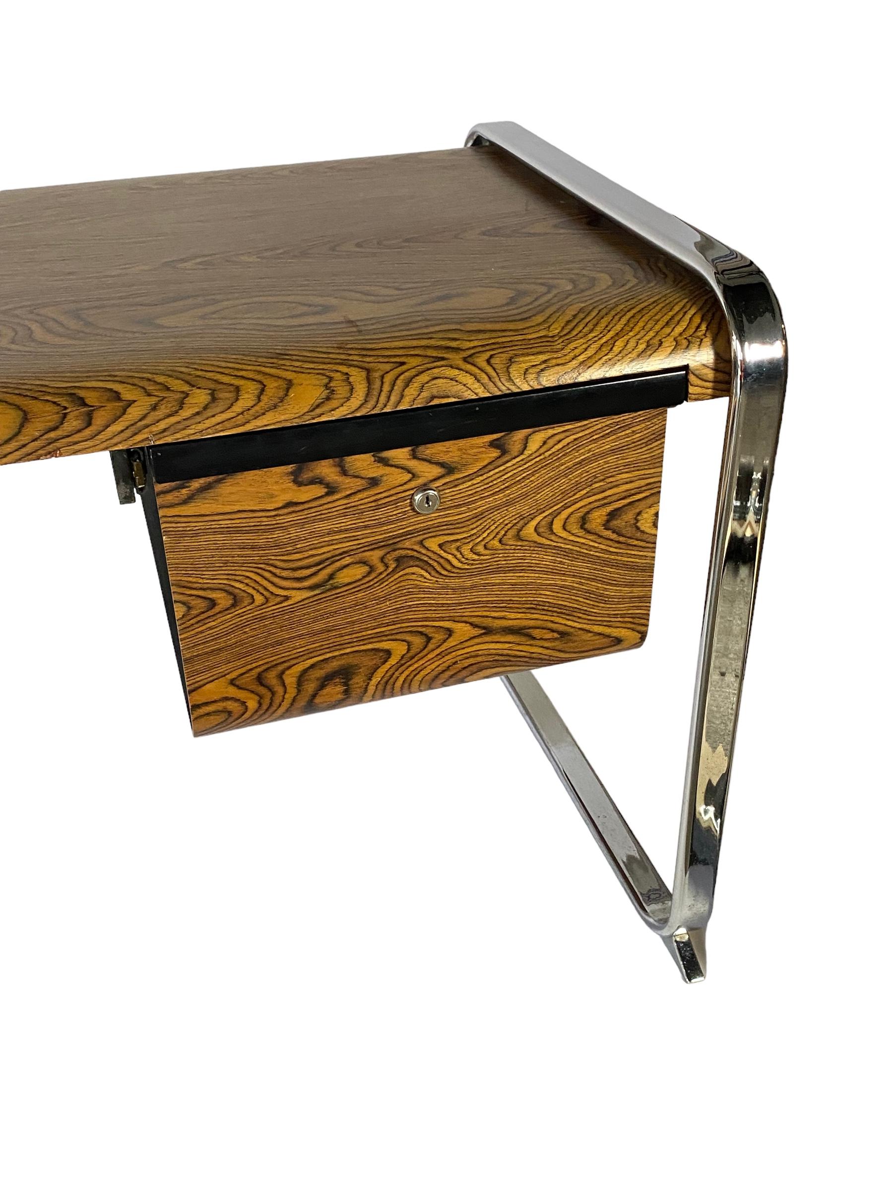 Beautiful iconic, Mid-Century Modern desk designed by Peter Protzman and manufactured by Herman Miller. This design was only produced for a handful of years and is definitely a difficult item to track down. Featuring molded Zebra wood, work
