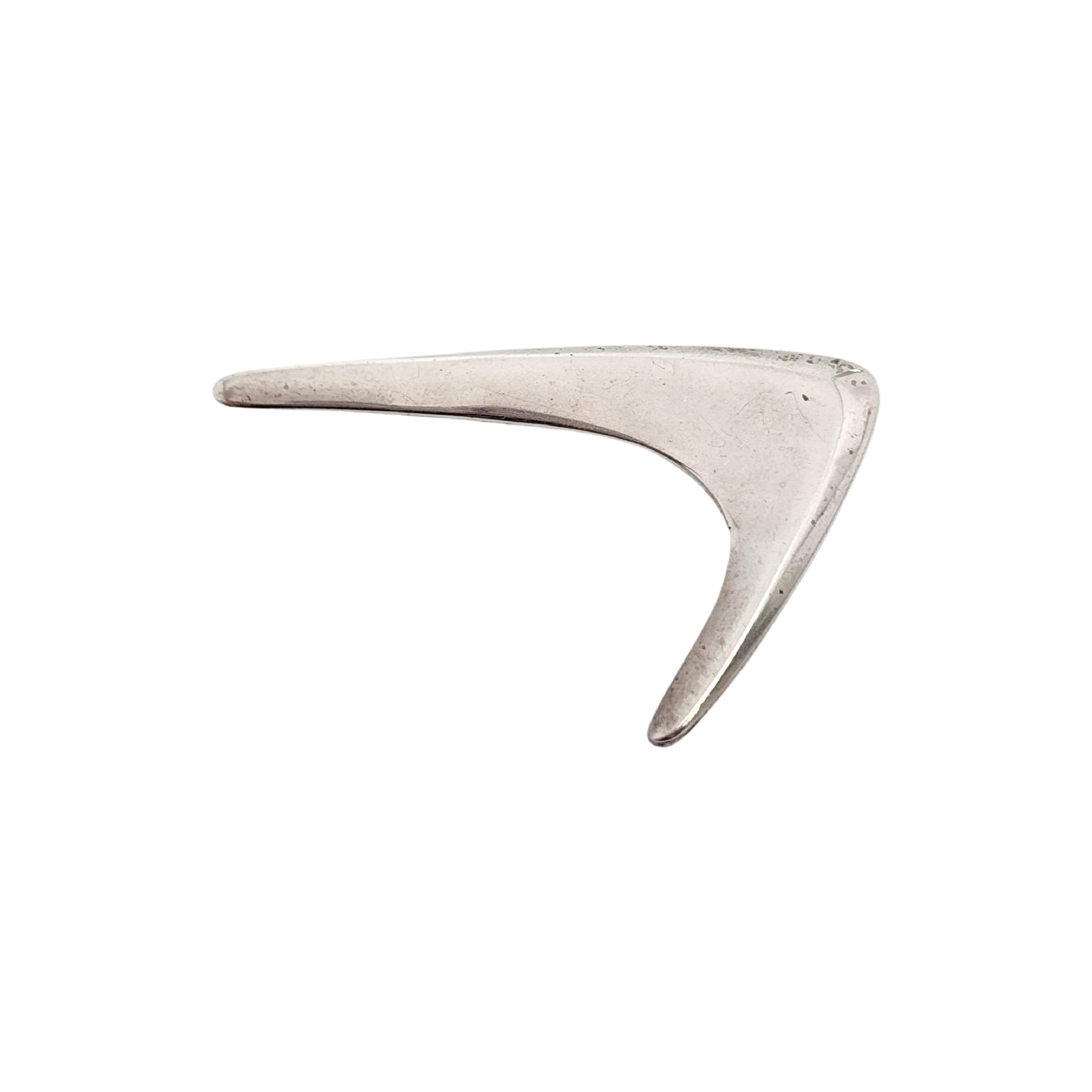 Bumerang-Anstecknadel/Brosche aus Sterlingsilber von Hermann Siersbol aus Dänemark.

Modernistische Brosche in Bumerangform.

Maße: ca. 2 1/8