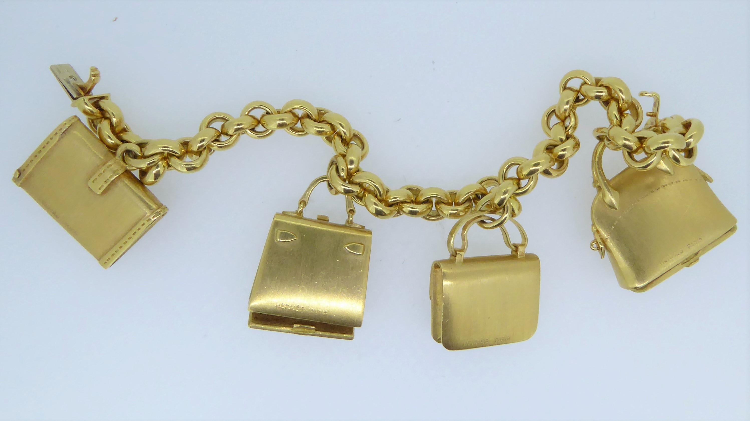 Hermes 18 Carat Yellow Gold Handbag Charm Bracelet. Adorned with 4 different matching Hermes Handbag styles. Two charms which open at the base. Weighs approx 91.3 grams. All bags signed 