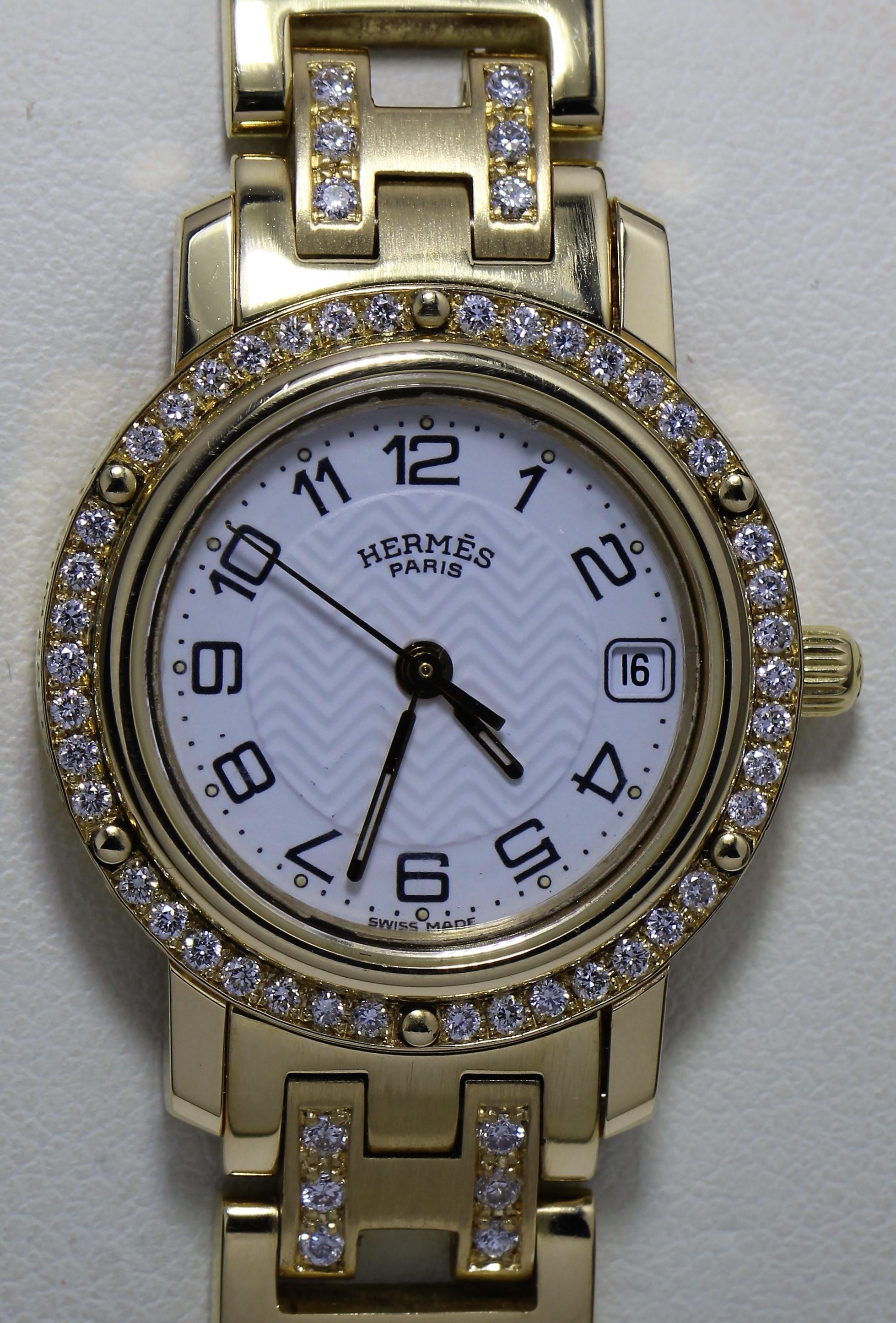 Hermes 18k Gold Watch with Diamond Studded Bezel and Belt

Roman numeral face with date
Belt is studded with diamonds in H pattern (54 diamonds) and bezel is studded with 42 diamonds