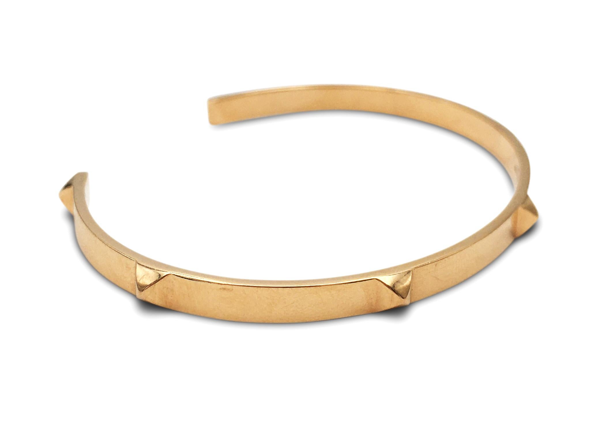 Authentic Hermes bangle bracelet made in 18 karat rose gold.  CIRCA 2010's. This elegant bracelet features 7 four-sided domed studs and can fit up to a size 6 1/2 wrist.  The bracelet is accompanied by its original Hermes box.