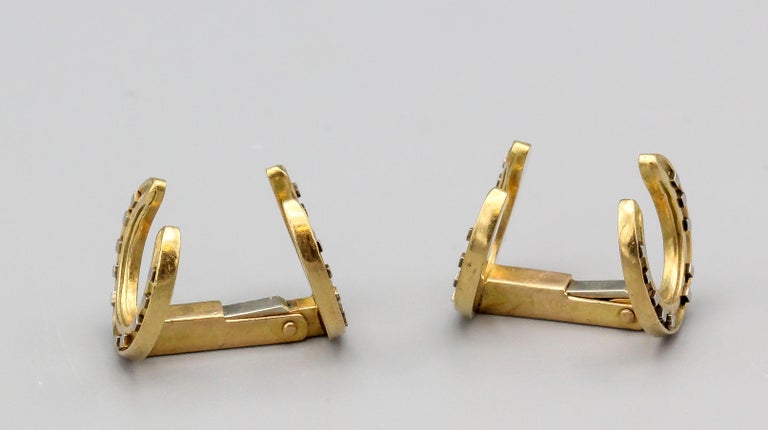 Fine pair of 18K yellow gold folding horseshoe cufflinks by Hermes, circa 1970s.  Featuring horseshoes on either side, the cufflinks offer an element of white gold as seen in the nails of the horseshoe; quite a rare pair.

Hallmarks: Hermes Paris,