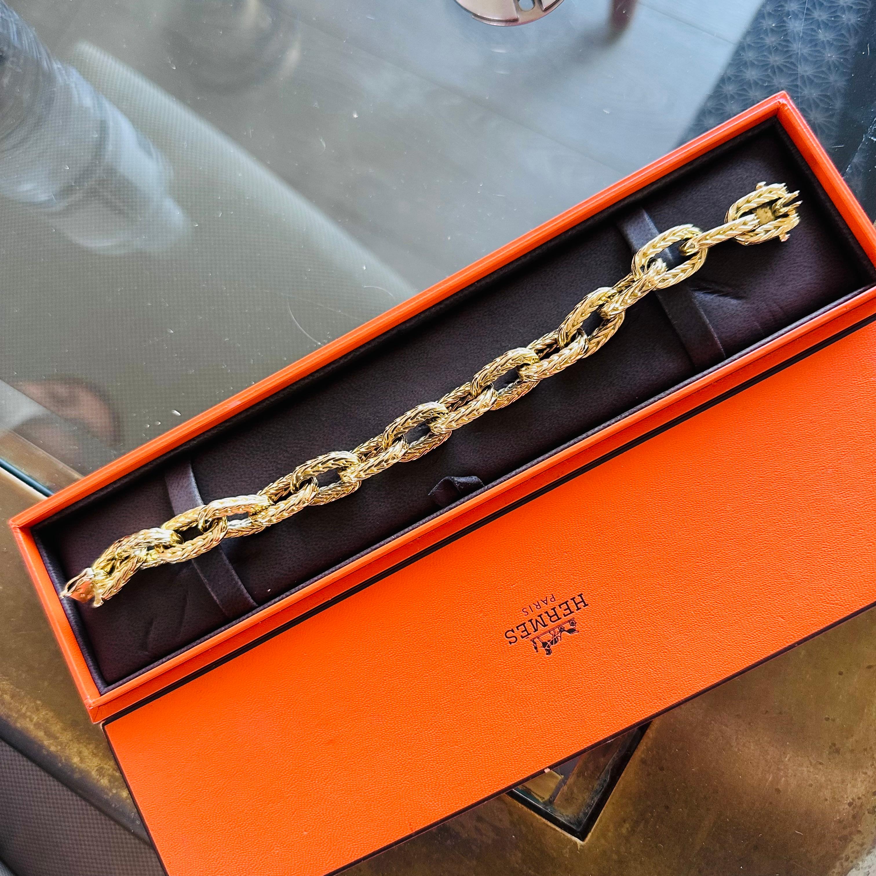Hermes 18k Yellow Gold Link Bracelet.
18k Yellow Gold 
8 Inches Length 
Rare Large Size 108 g total Weight
16 Handmade Woven Links in a Herringbone motif
1970's Signed Hermas , Hallmarks for L'Enfant and other Stamps. 
Georges L'Enfant was a