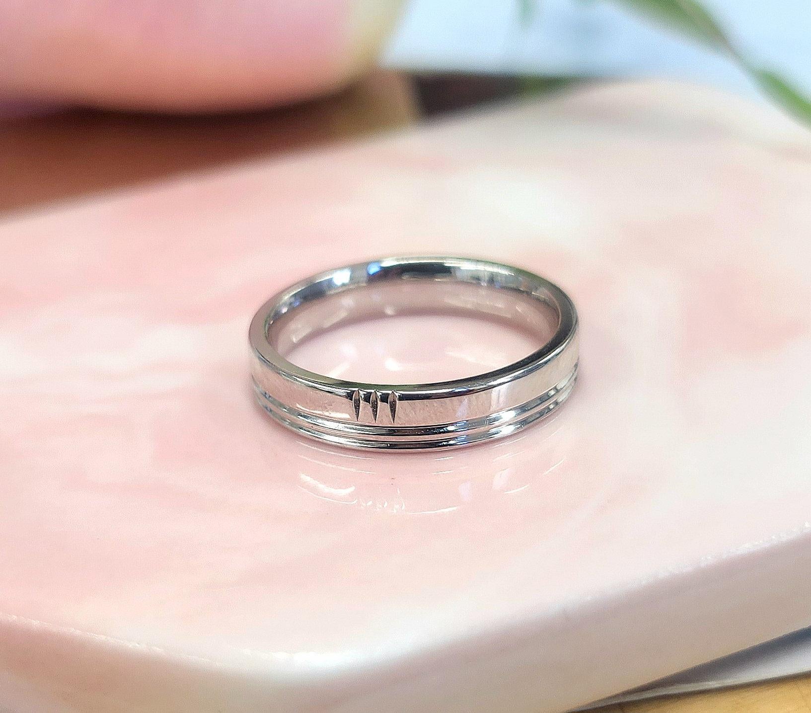 Discover the perfect blend of sophistication and subtle luxury with this stunning Hermes 18K white gold ring. Featuring a unique grooved design with three elegant stripes, this band is a chic and versatile addition to any jewelry
