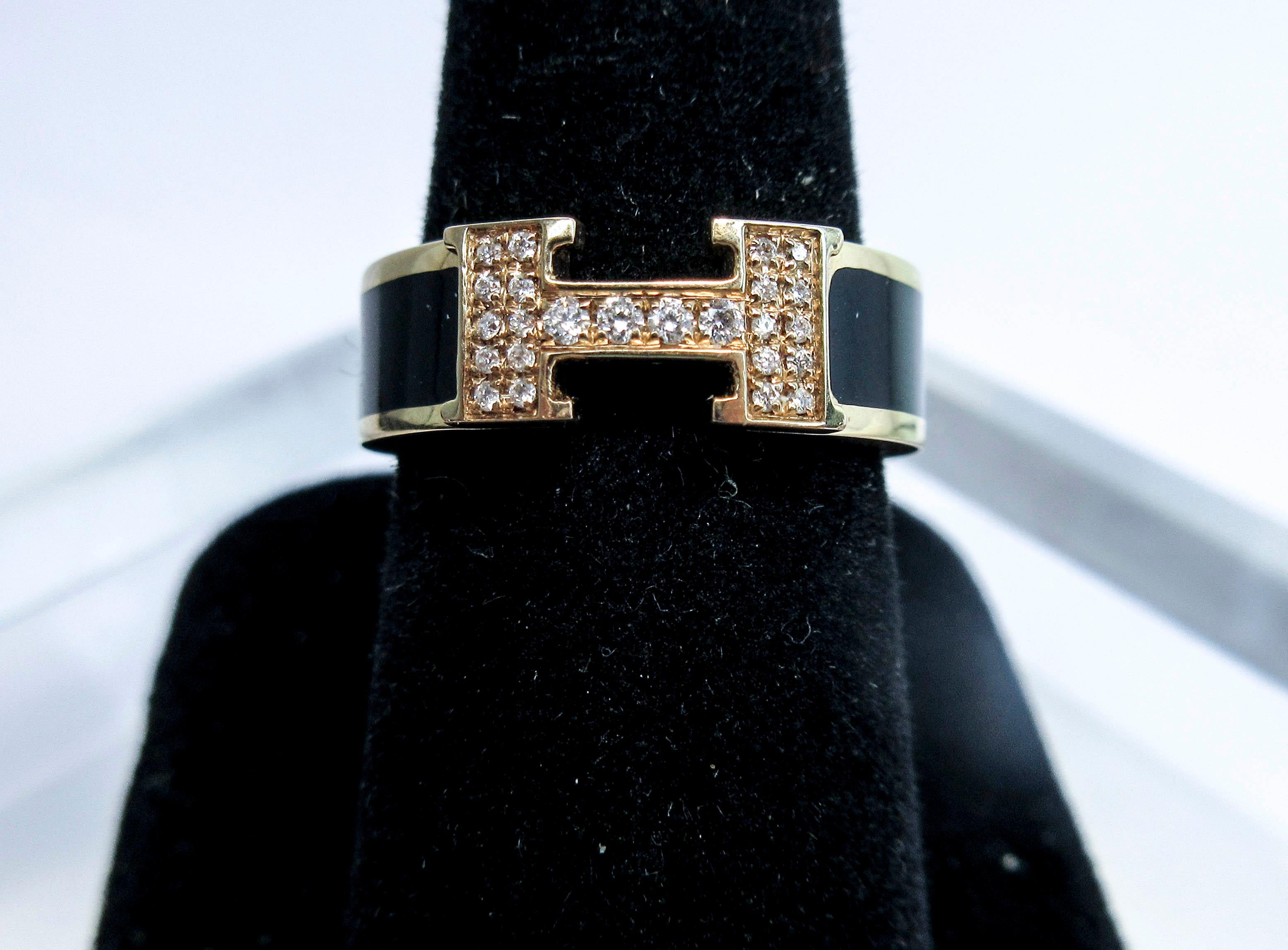 This Hermes ring is composed of 18kt rose gold with black enamel, and features a diamond pave 'H' classic design. Size 6.5. Please feel free to ask any additional you may have. 