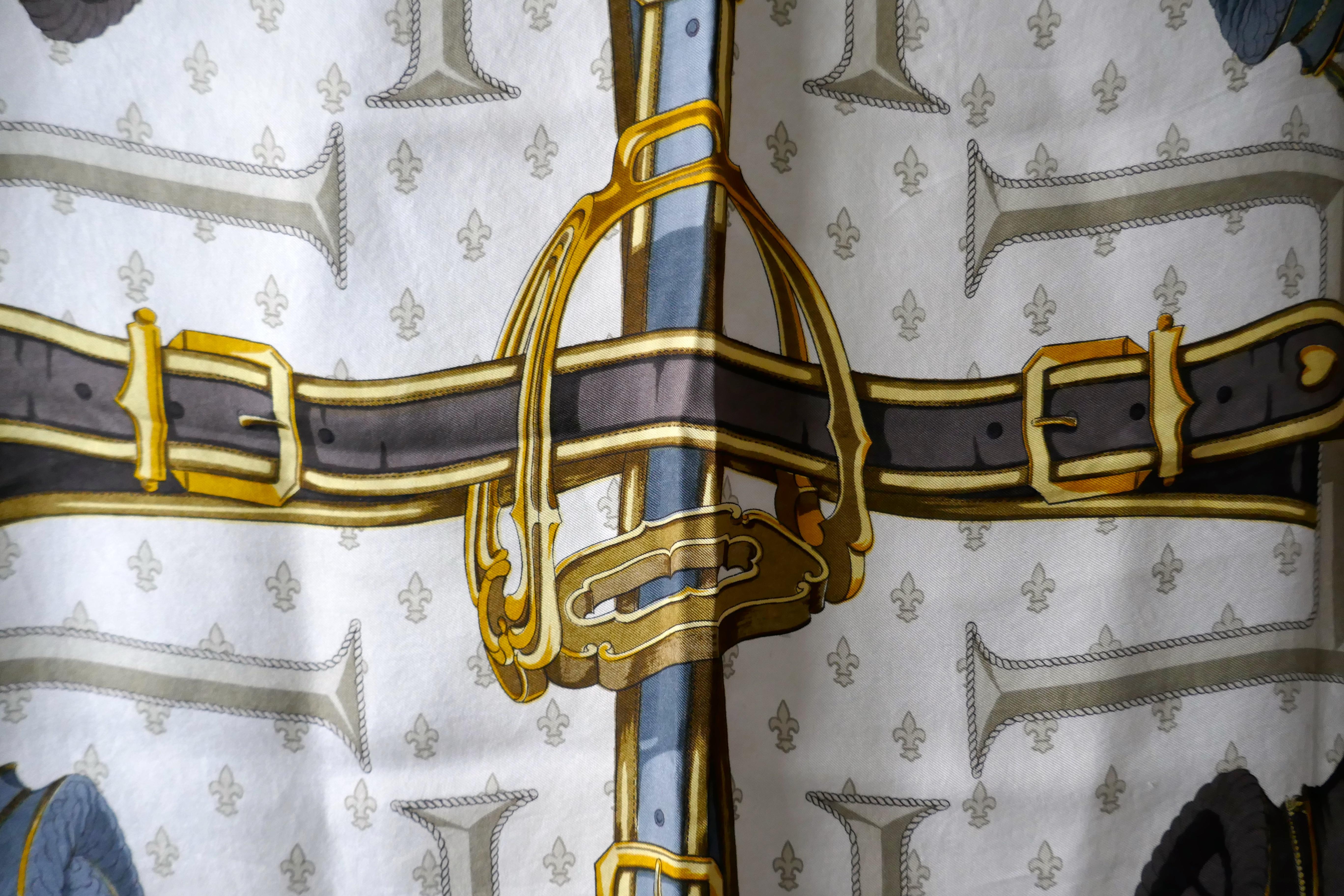 HERMÈS 1967  Silk Scarf designed by Christine Vauzelles “Selles a Housse” 

That much loved subject of the Hussars and their Horses, with the Giant H worked in to all the quarters of the design with Fleurs des Lys background
A Classic from 1967 in