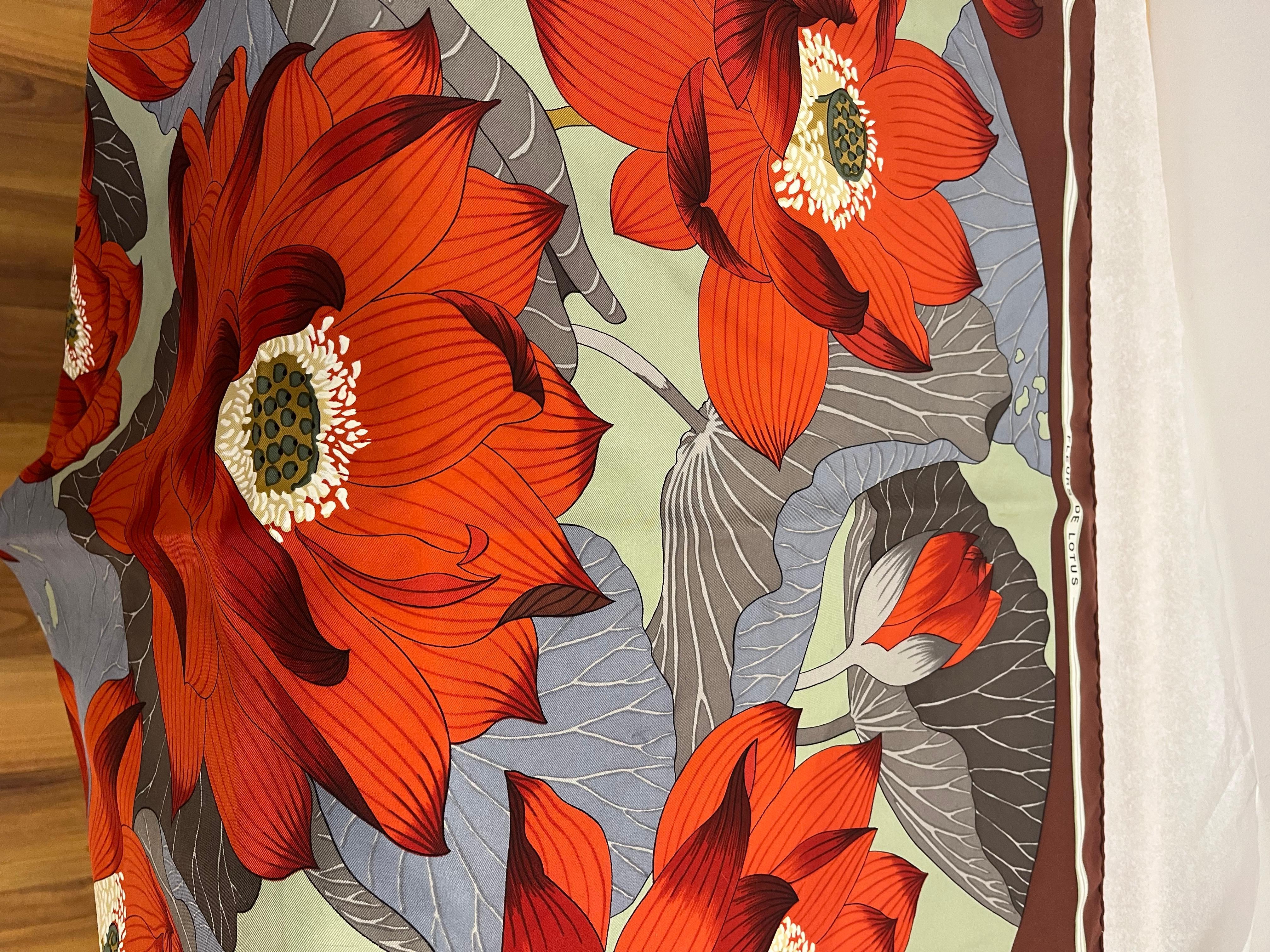 Stunning and colorful Hermes silk scarf designed by Christiane Vauzelles, featuring the lotus flower and greenery. The scarf is shown worn as a head scarf, but can also be rolled on your bag handle, and of course worn around the neck.

The hems are