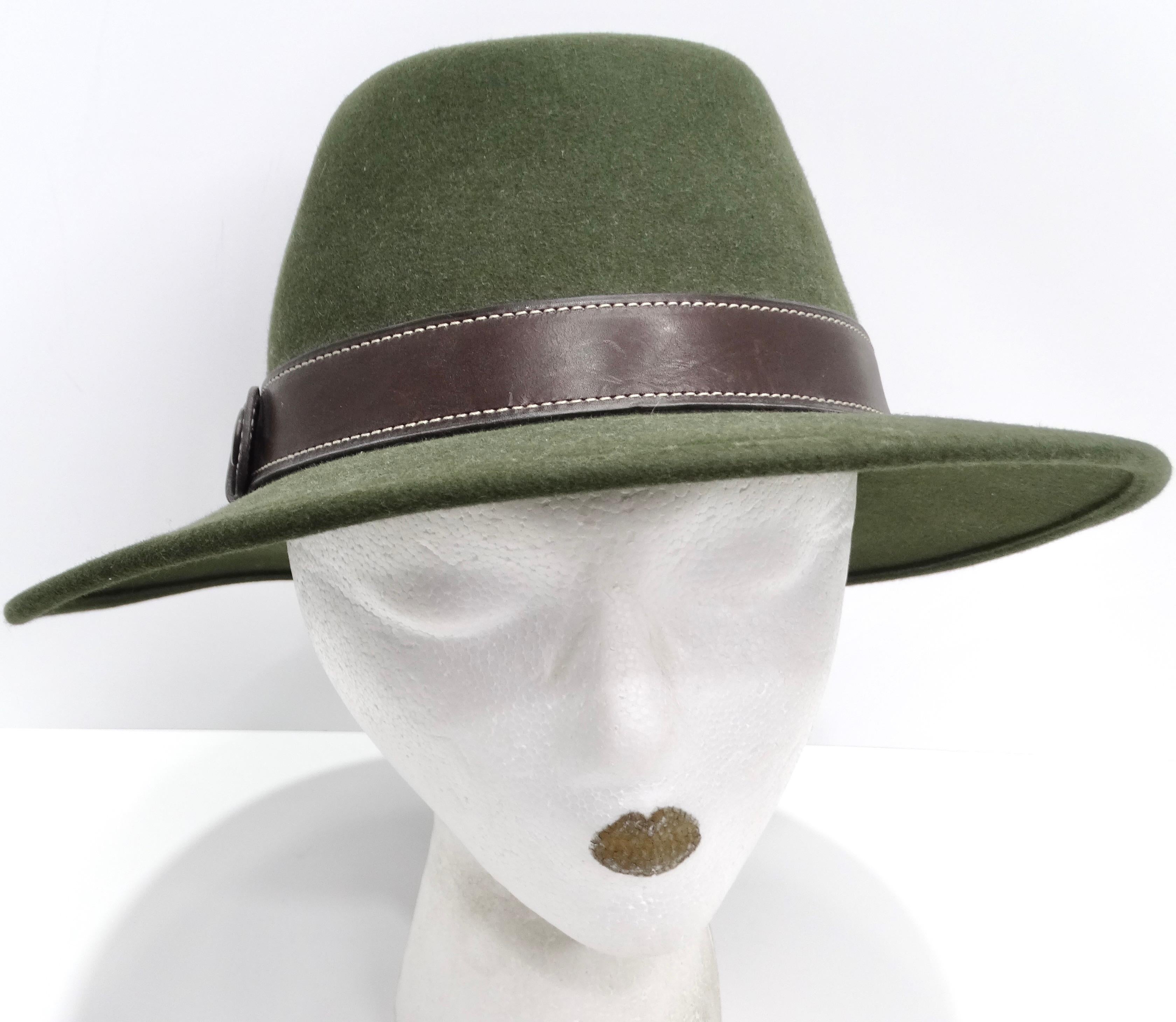 Introducing the timeless elegance of the Hermes 1980s Green Wide Brim Hat, a classic and sophisticated accessory that exudes timeless style. Crafted from luxurious green wool, this wide-brim fedora hat features a sleek and chic design that is both