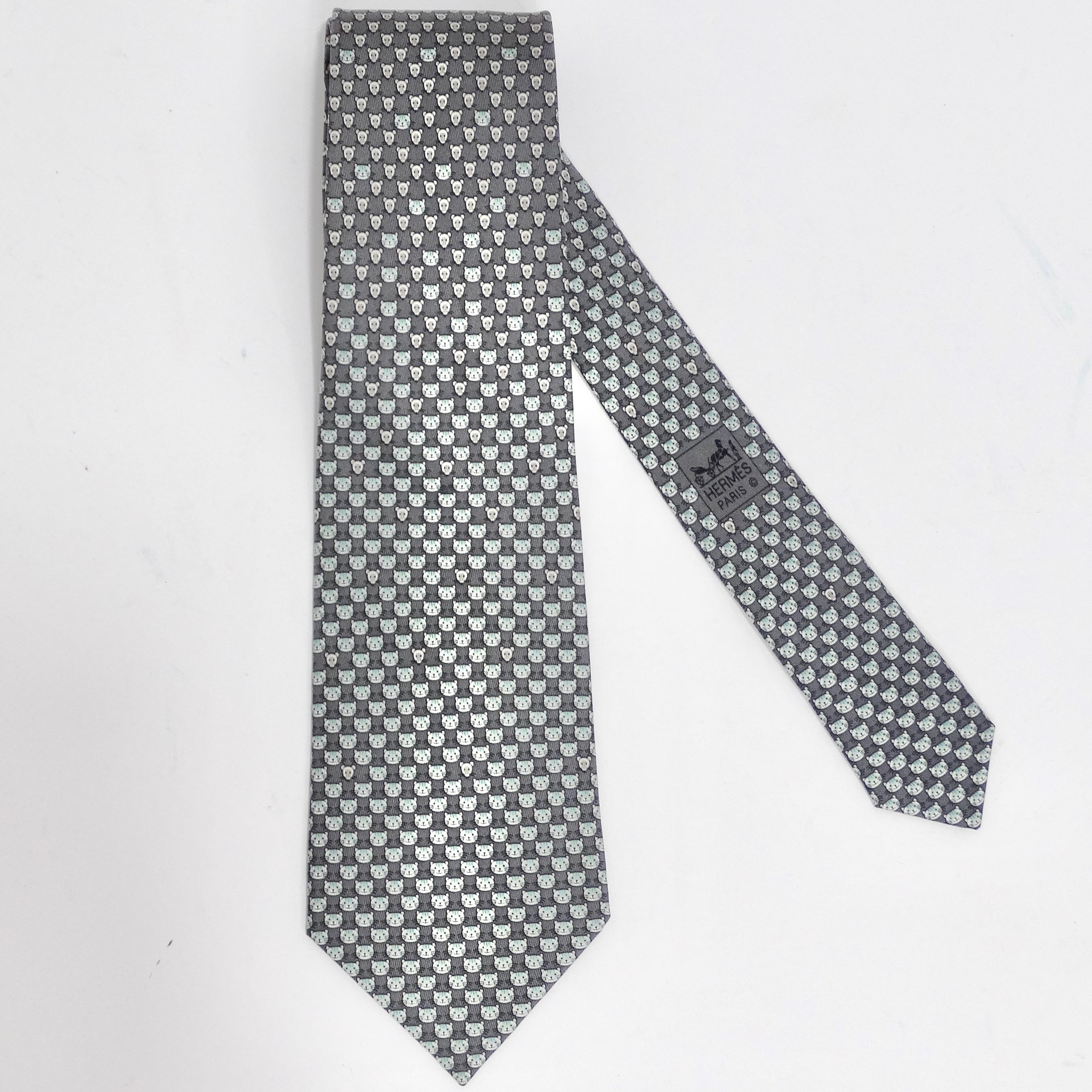 Introducing the Hermes 1990s Cat Print Tie – a classic closet staple with a charming twist! This tie seamlessly blends timeless elegance with a touch of feline whimsy. Crafted in a versatile neutral grey silk, it's adorned with an array of adorable