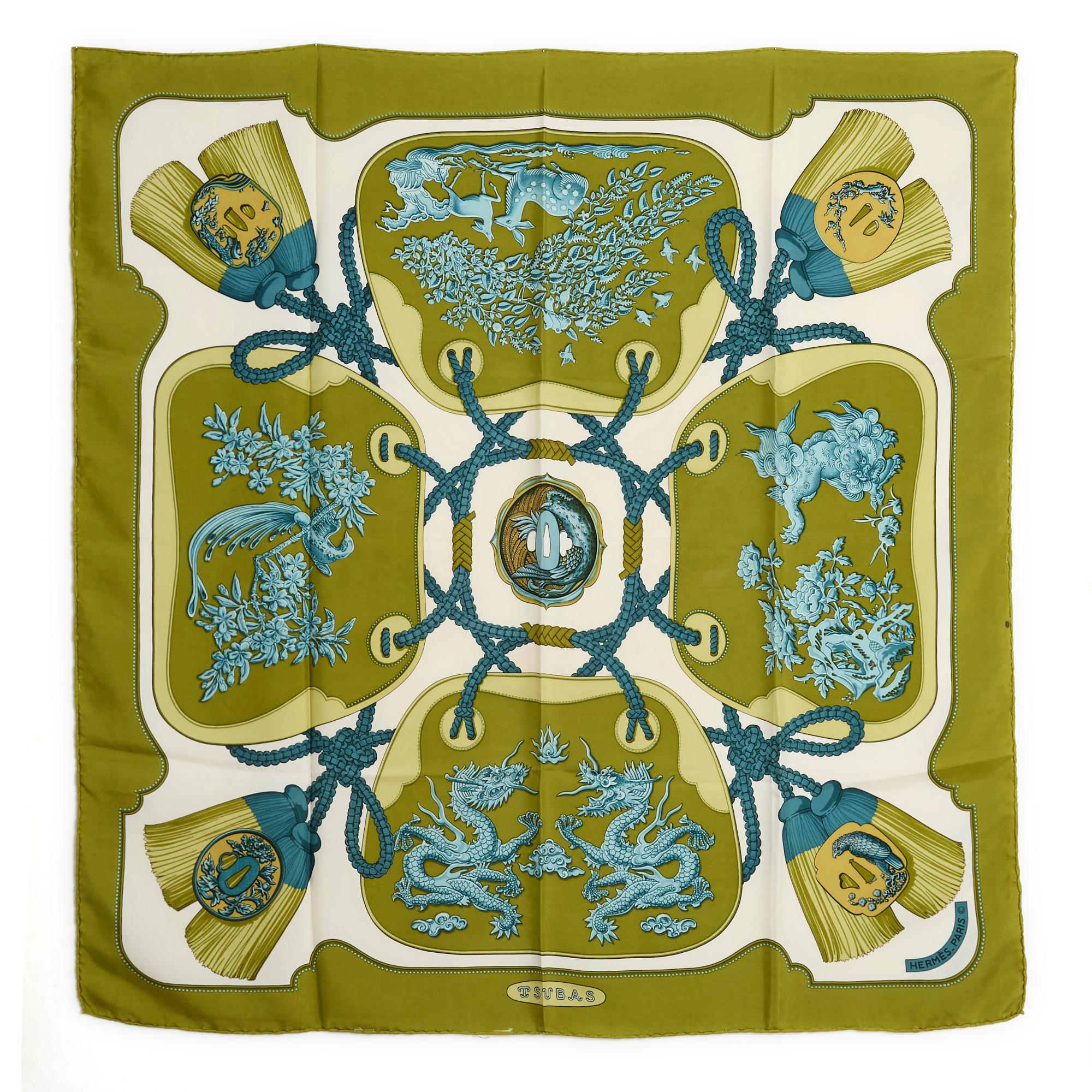 Hermès square 90 scarf in silk twill, Tsubas pattern by Christiane Vauzelles, published in 1991 and never reissued, patterns in different tones of blue, olive green edge and background. Width 90 cm x length 90 cm approximately. The square is vintage