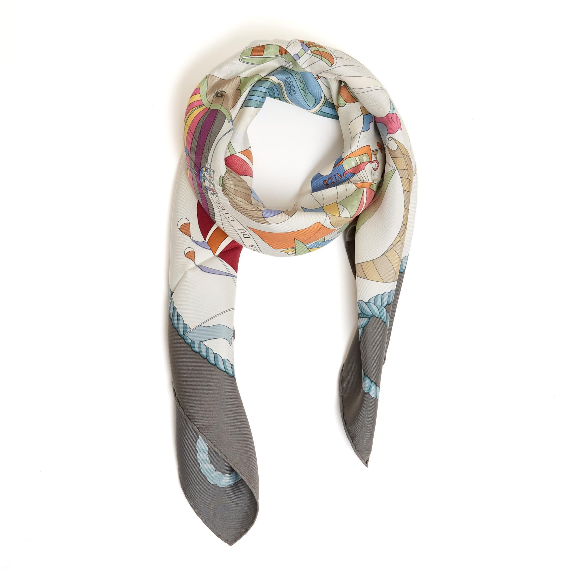Hermès square scarf 90 in silk twill, Les Folies du Ciel pattern by Loïc Dubigeon, published in 1984 and reissued in 1988 and then in 1994 (like this one), in pastel shades on an ecru background, dark gray edge. Width 90 cm x length 90 cm