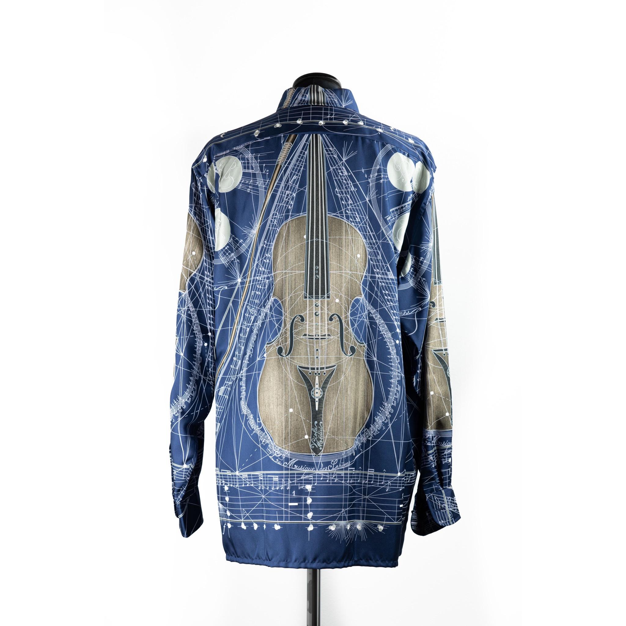 Hermès shirt in 100% silk.
Fabric graphic designed by Zoe Pavwels.
Zoe created this elegant piece in 1996. Titled 'La Musique Des Spheres', it depicts a celestial and musical Stradivarius violin and tells the legend that the stars, in perpetual