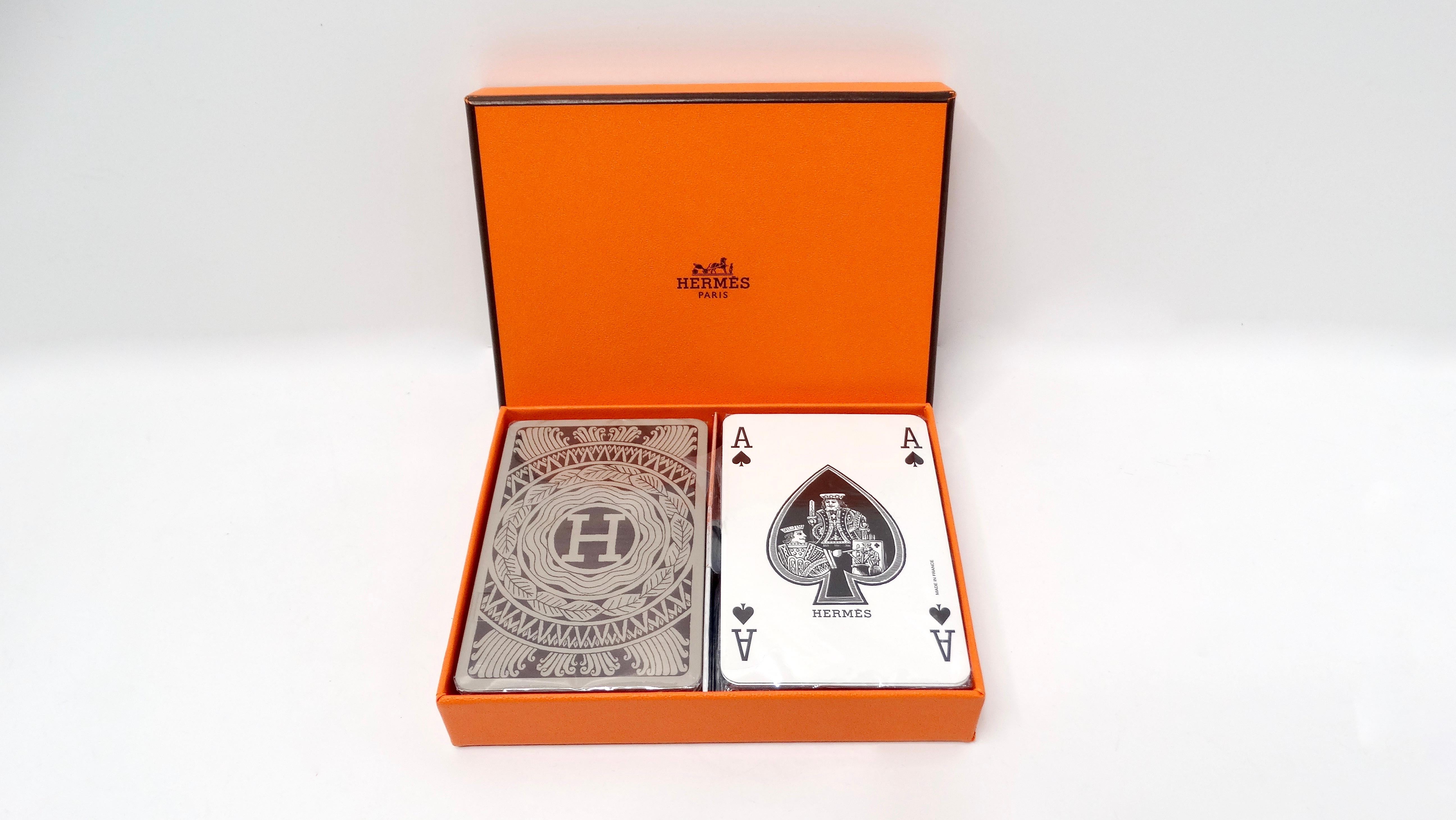 The Hermès 2-Deck Playing Card Box Set is a luxurious addition to any game night or home decor. Housed in the iconic Hermès orange box, this set not only makes a statement but also exudes sophistication. The two decks feature distinct designs: one