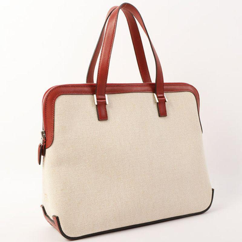 Hermes 2001 Made Escapada Natural/Rouge Top Handle Bag Vif

Additional information:
Interior pocket x1
Material: Toile H 2001
Made in France .
Size: 30 W x 9 D x 25 H cm
Handle 37cm.
Condition: Good
Front: No obvious damage
Back: No obvious
