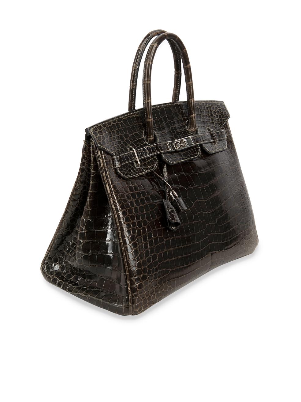 CONDITION is Very good. Minimal wear to bag is evident. Minimal wear to the front, base handles and sides with light scratches and abrasions to the crocodile leather. The metal hardware also has very light scratches to the silver plating at the