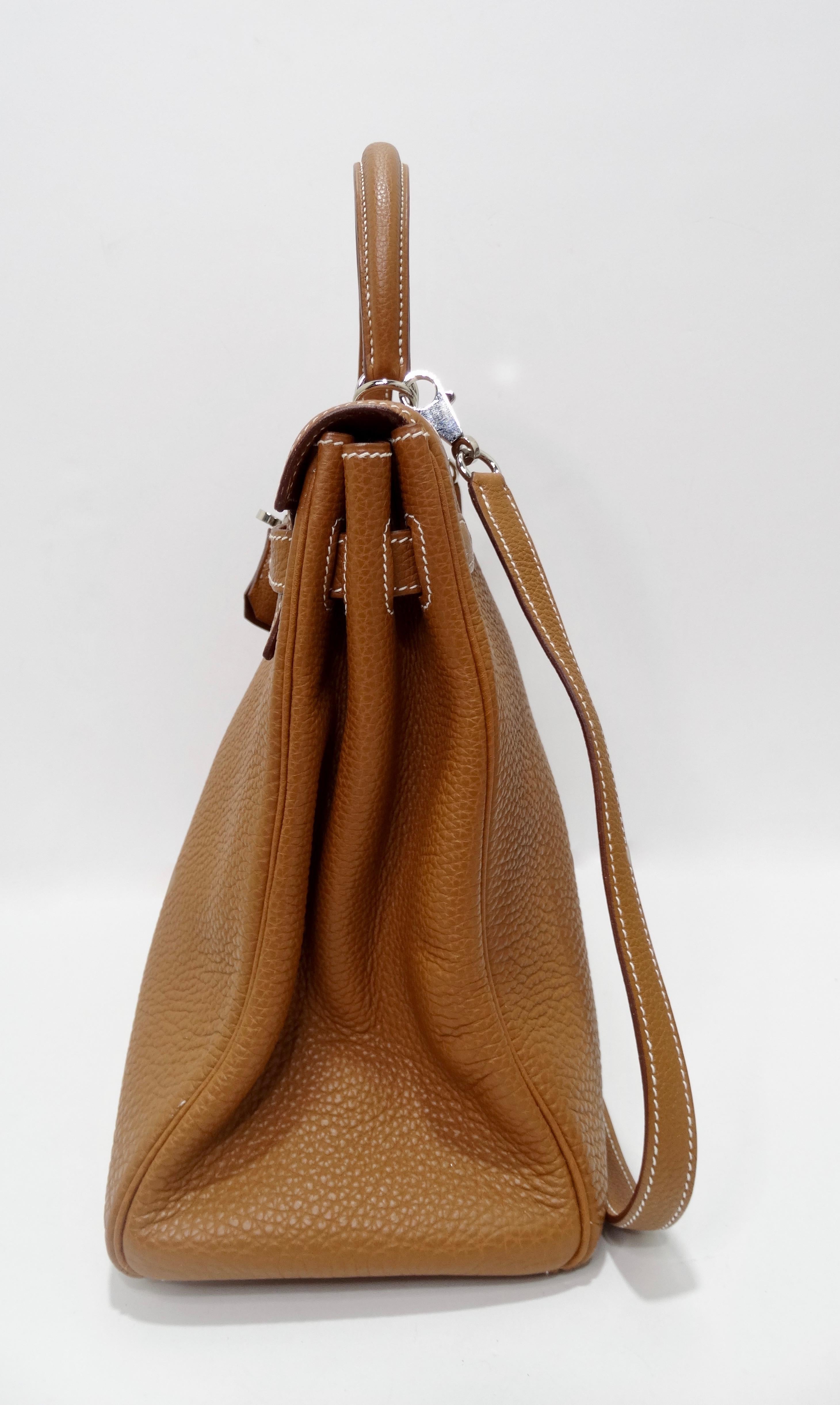 Hello Hermés! Handcrafted by the artisans of Hermes into an iconic 35cm Kelly from 2005. This Hermes Kelly handbag is crafted from togo leather in a beautiful shade of golden brown with Palladium hardware. Features white stitching, single rolled top