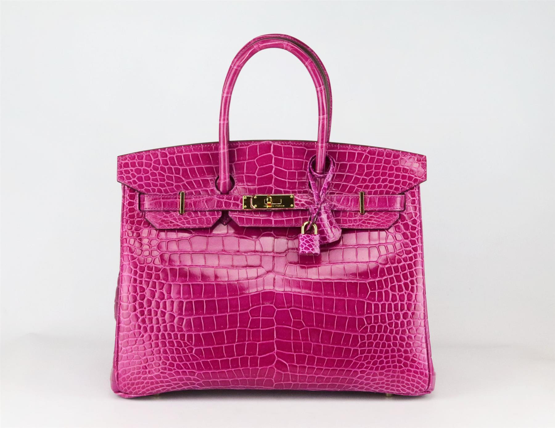 Made in France, this beautiful 2008 Hermès ‘Birkin’ 35cm handbag has been made from shiny Porosus Crocodile exterior in ‘Rose Scheherazade’ pink and matching leather interior, this piece is decorated with gold hardware on the front and finished with