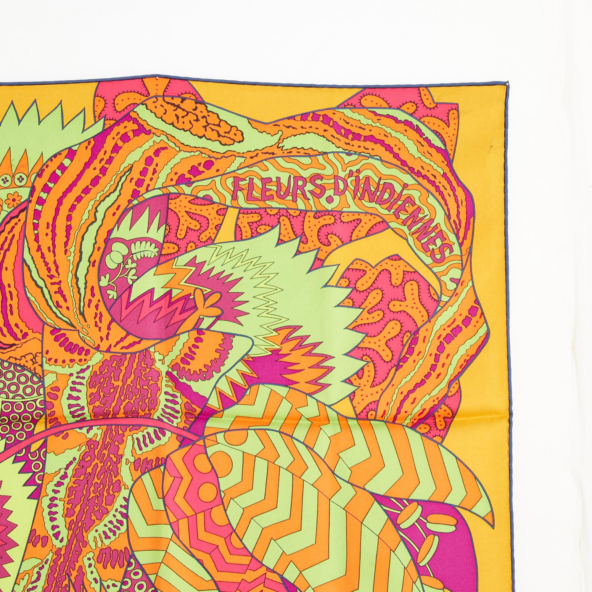 Hermès square scarf 90 in silk twill, Indian Flowers pattern by Aline Honoré, published in 2011, in shades of green, red, saffron, edge (rolled) colored in blue. Width 90 cm x length 90 cm approximately. The square has been worn but it seems in