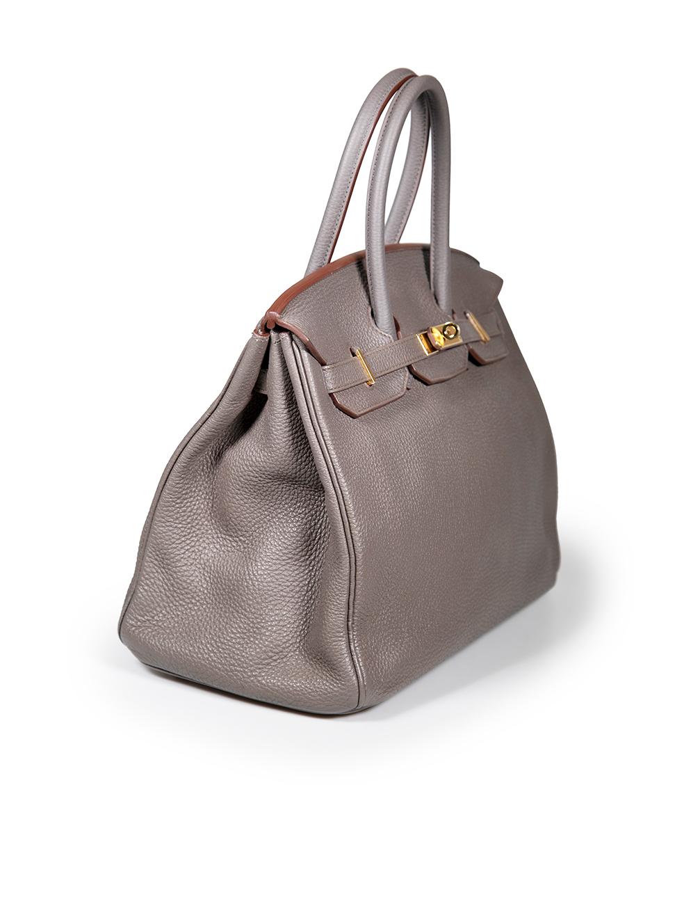 CONDITION is Very good. Minimal wear to bag is evident. Minimal wear to sides where leather had cracked around the top seam. There is tarnishing to the base feet and pen marks throughout the lining on this used Hermès designer resale item. This item