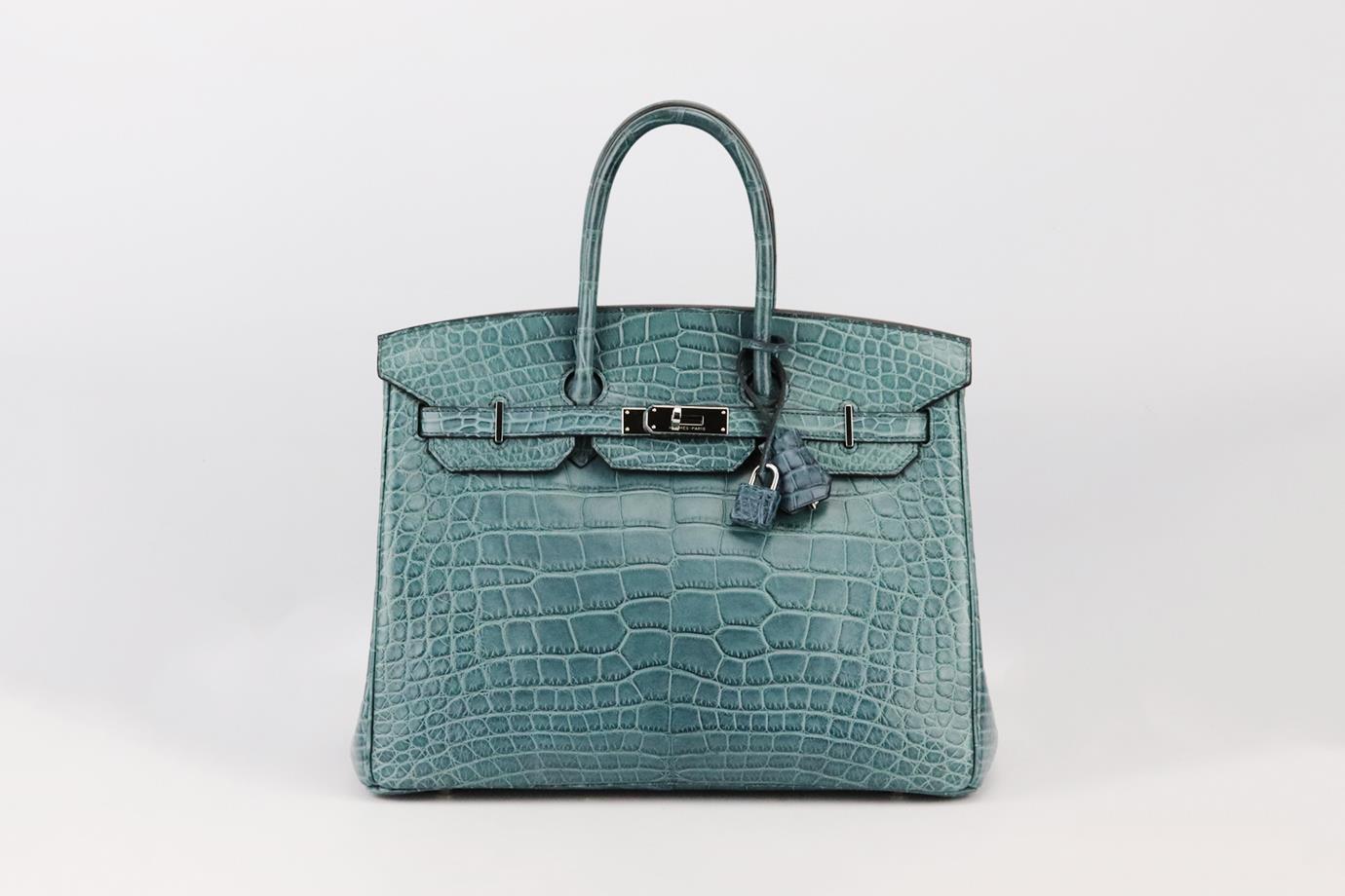 Hermès 2013 Birkin 35cm Matte Alligator Mississippiensis leather bag. Made in France, this beautiful 2013 Hermès ‘Birkin’ handbag has been made from blue-tone ‘Alligator Mississippiensis’ exterior in ‘Tempete’ with matching leather interior, this