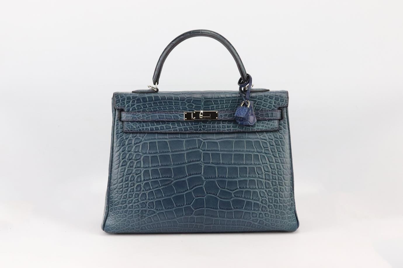 Hermès 2013 Kelly 35cm Bi-Colour Matte Alligator Mississippiensis leather bag. Made in France, this beautiful 2013 Hermès ‘Kelly’ handbag has been made from blue ‘Alligator Mississippiensis’ exterior in ‘Bleu de Malte’ with purple leather interior