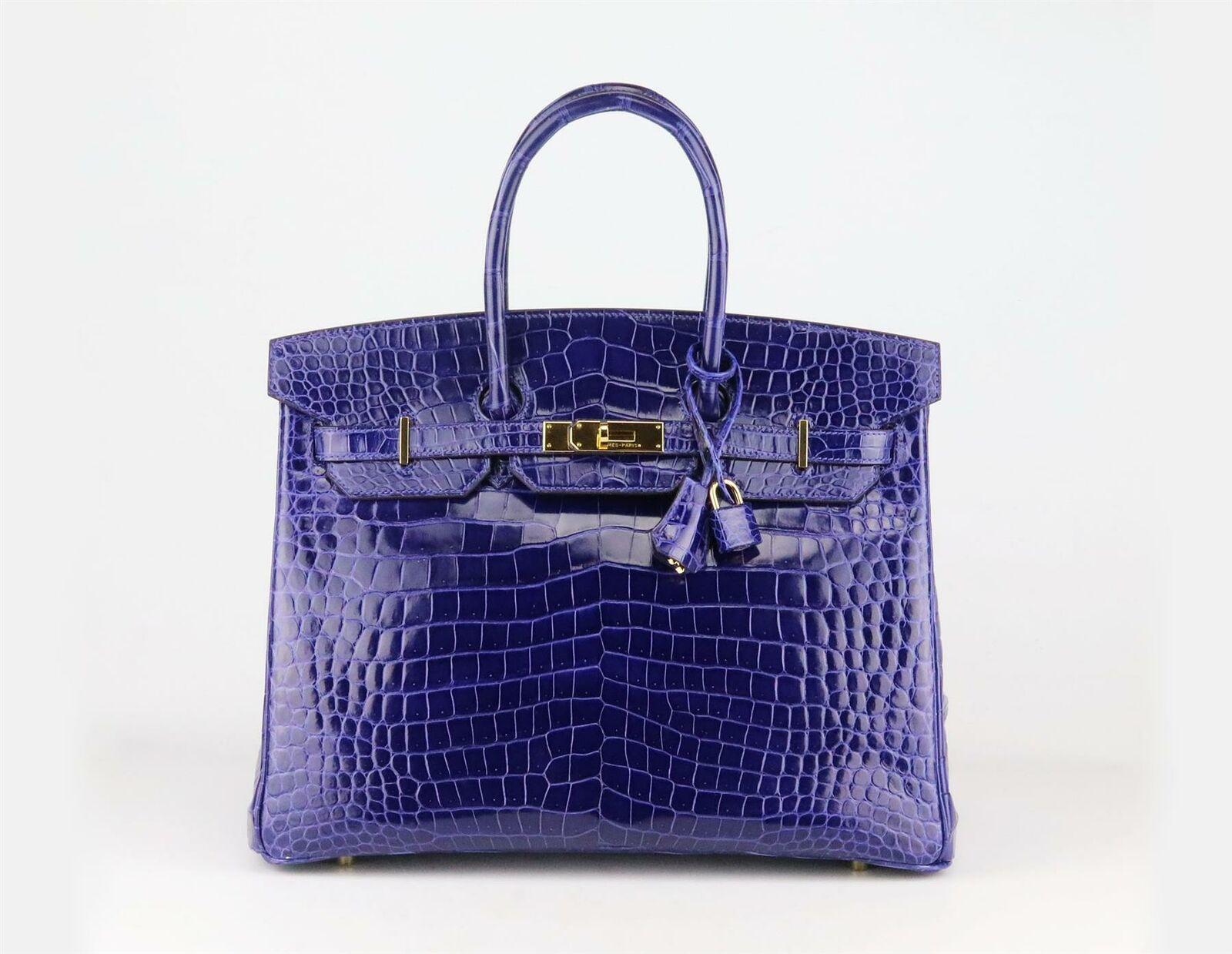 Made in France, this beautiful 2014 Hermès ‘Birkin’ 35cm handbag has been made from shiny Porosus Crocodile exterior in ‘Royal Blue’ and matching leather interior, this piece is decorated with gold hardware on the front and finished with top