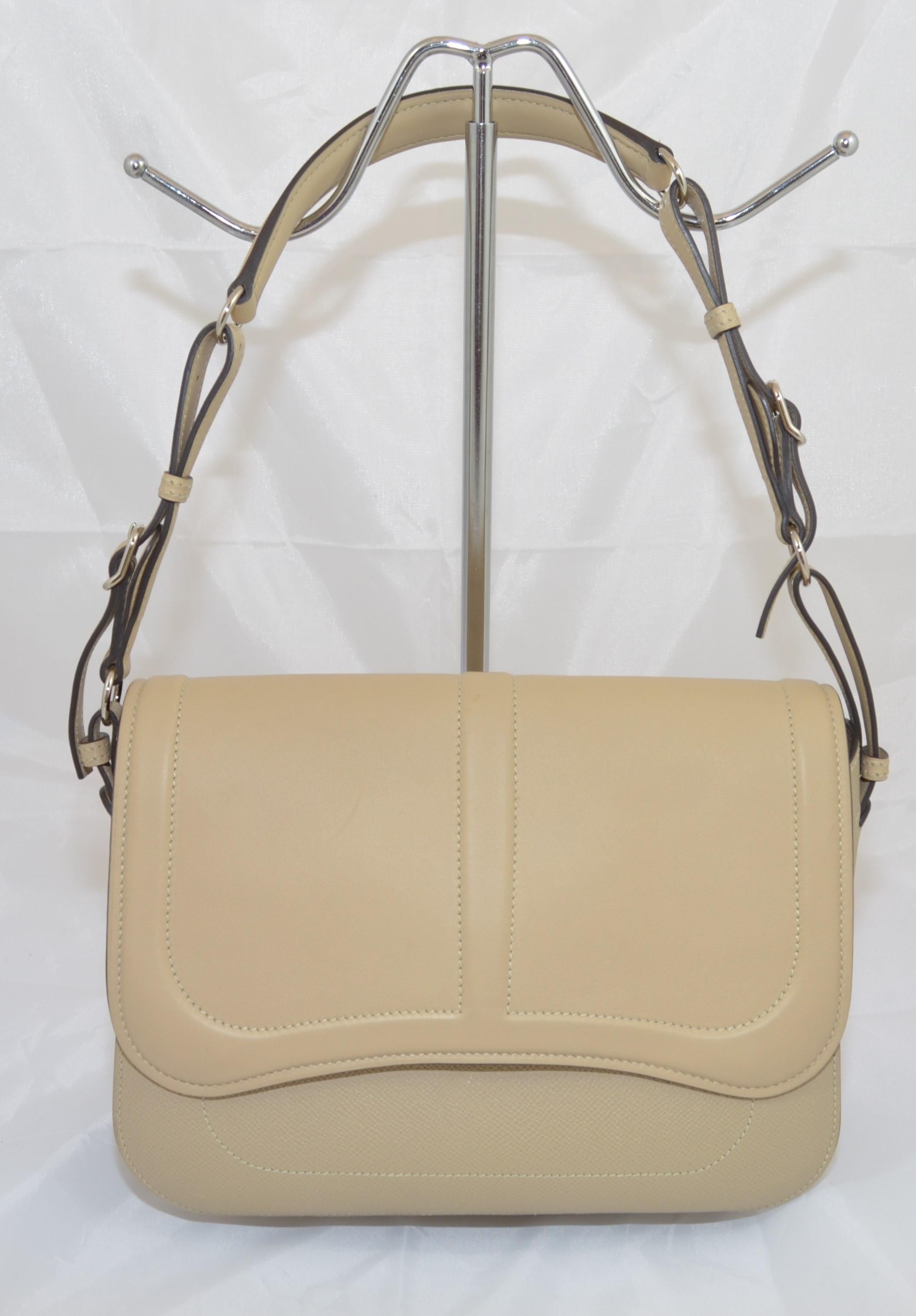 Hermes Harnais khaki-colored shoulder bag features an adjustable leather shoulder strap with polished palladium hardware, and a leather crossover flap. Interior is fully lined in leather with patch pockets. Bag is stamped X (no shape) dating it to