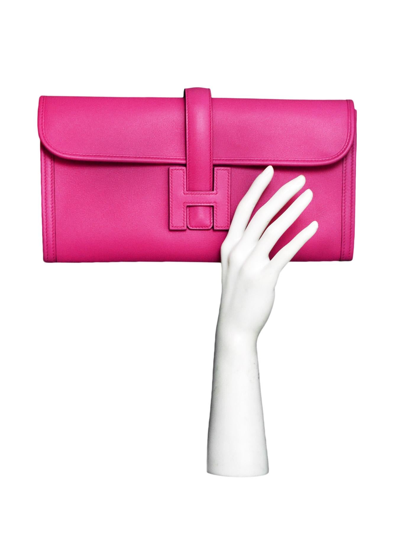 Hermes Magnolia Pink Swift Leather Jige Elan 29 Clutch Bag

Made In: France
Year of Production: 2018 (C stamp)
Color: Magnolia pink
Materials: Swift leather 
Lining: Pink leather
Closure/Opening: Flap top with slide through H tab
Exterior Pockets: