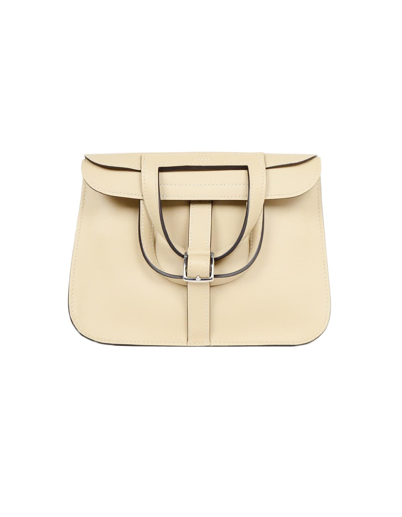Hermes 2018 Trench Swift Leather Halzan Mini 22 Bag

Made In: France
Year of Production: 2018
Color: Trench (taupe)
Hardware: Palladium 
Materials: Swift leather
Lining: Trench leather
Closure/Opening: Fold over stirrup-shaped handles that can go