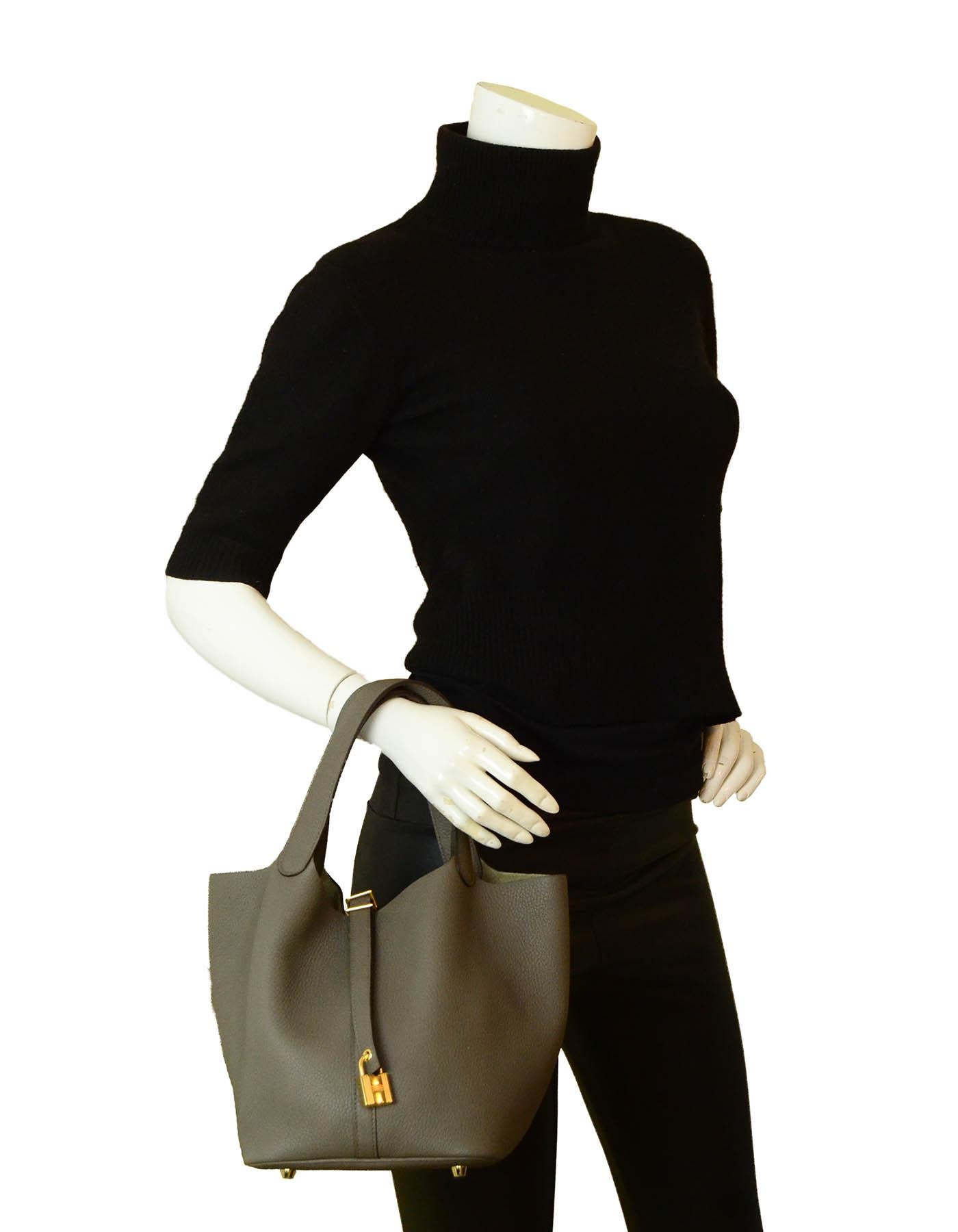 Hermes Etain Taurillon Clemence Leather Picotin Lock 22 MM Bag

Made In: France
Year of Production: 2020
Color: Etain grey
Hardware: Goldtone
Materials: Taurillon clemence leather
Lining: Suede
Closure/Opening: Open top with center tab
Exterior
