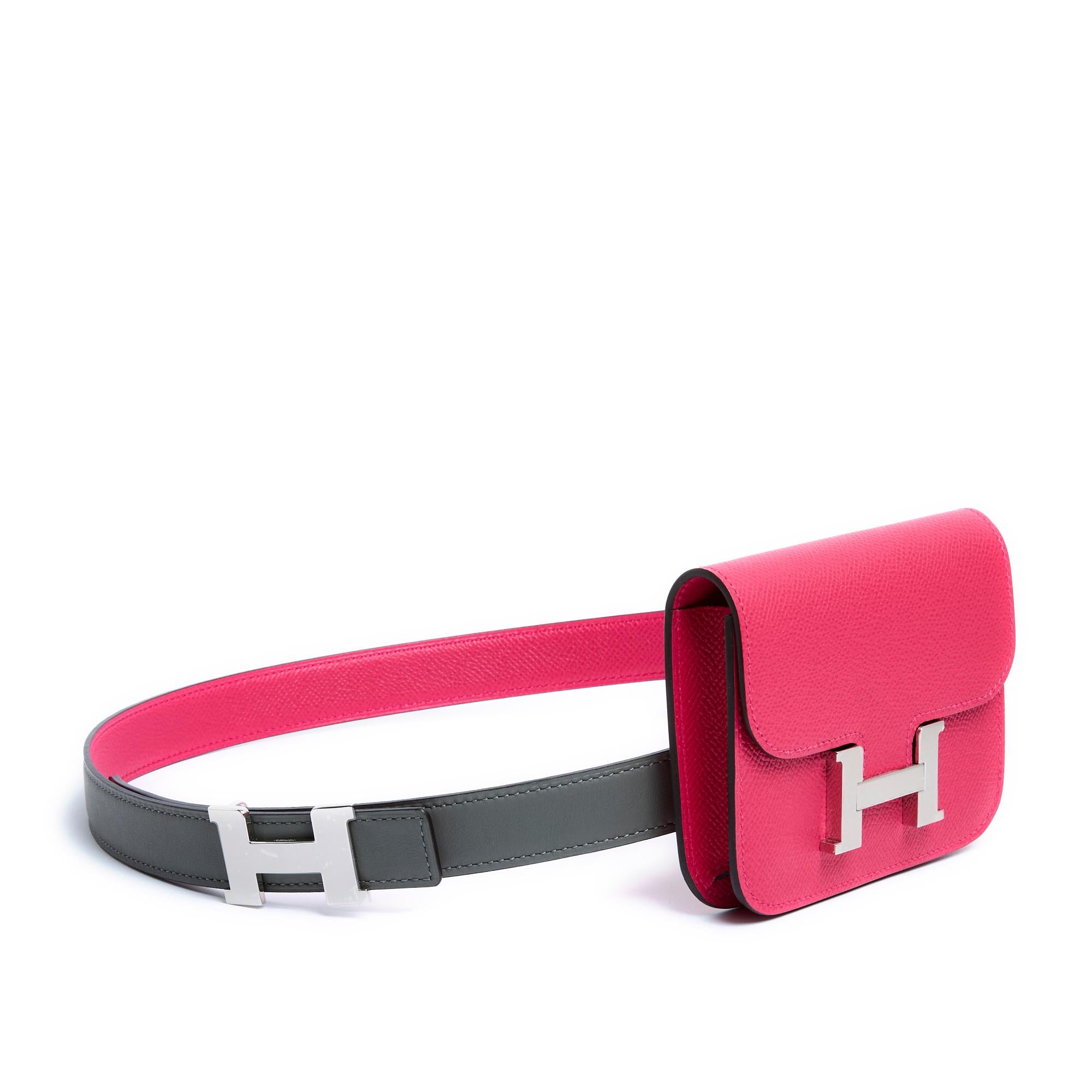 Hermès clutch, Constance Slim model, in pink (Mexico) Epsom leather, interior in smooth pink leather and coordinated removable coin purse, H click clasp in shiny silver metal (palladium), a wide belt loop on the back and its matching belt, series A