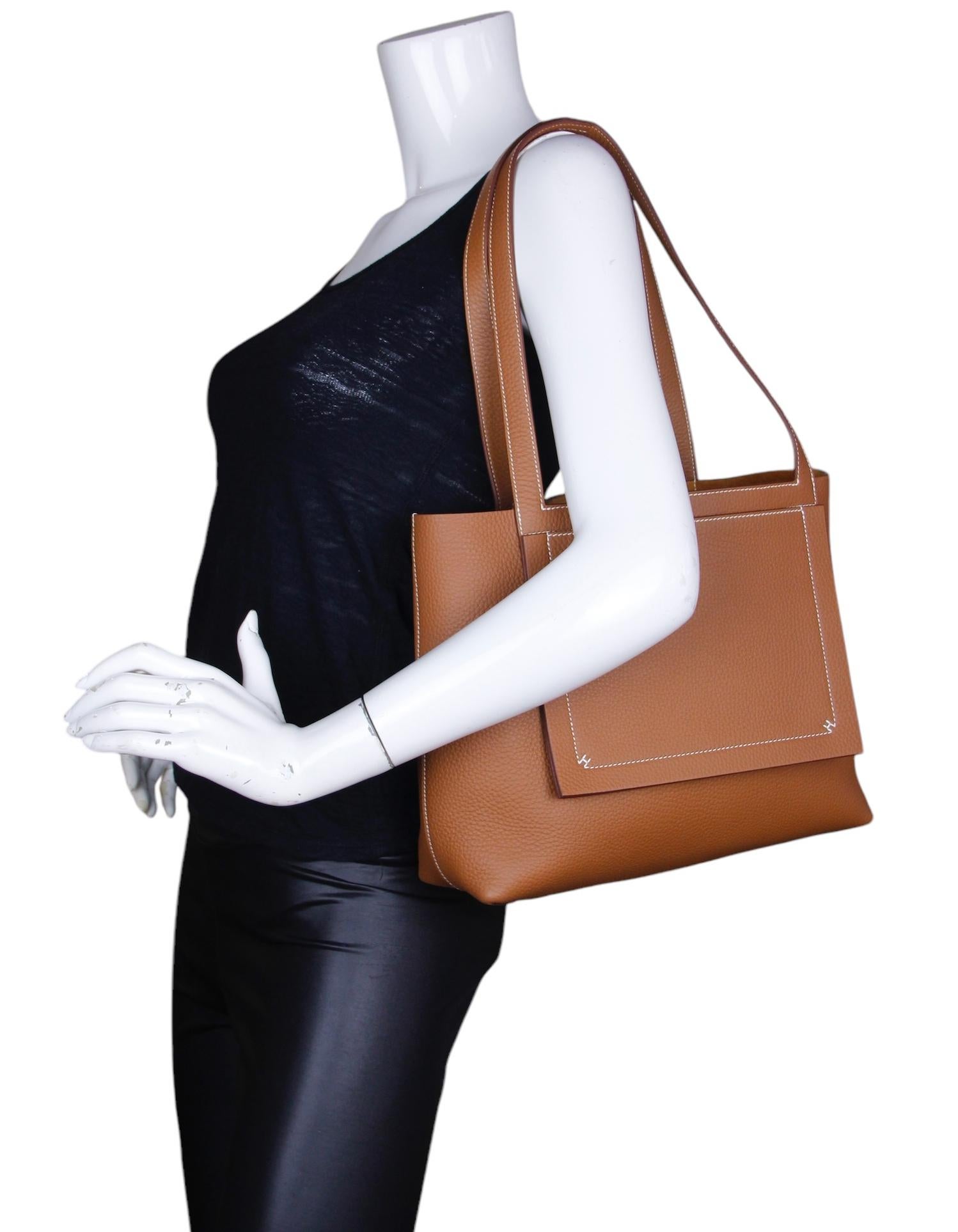 Hermes Gold Taurillon Clemence Leather Cabasellier 31 Tote Bag.  Features white contrast stitching.

Year of production: 2024
Made In: France
Color: Gold-tan color
Hardware: None
Materials: Taurillon clemence leather
Lining: Suede
Closure/Opening: