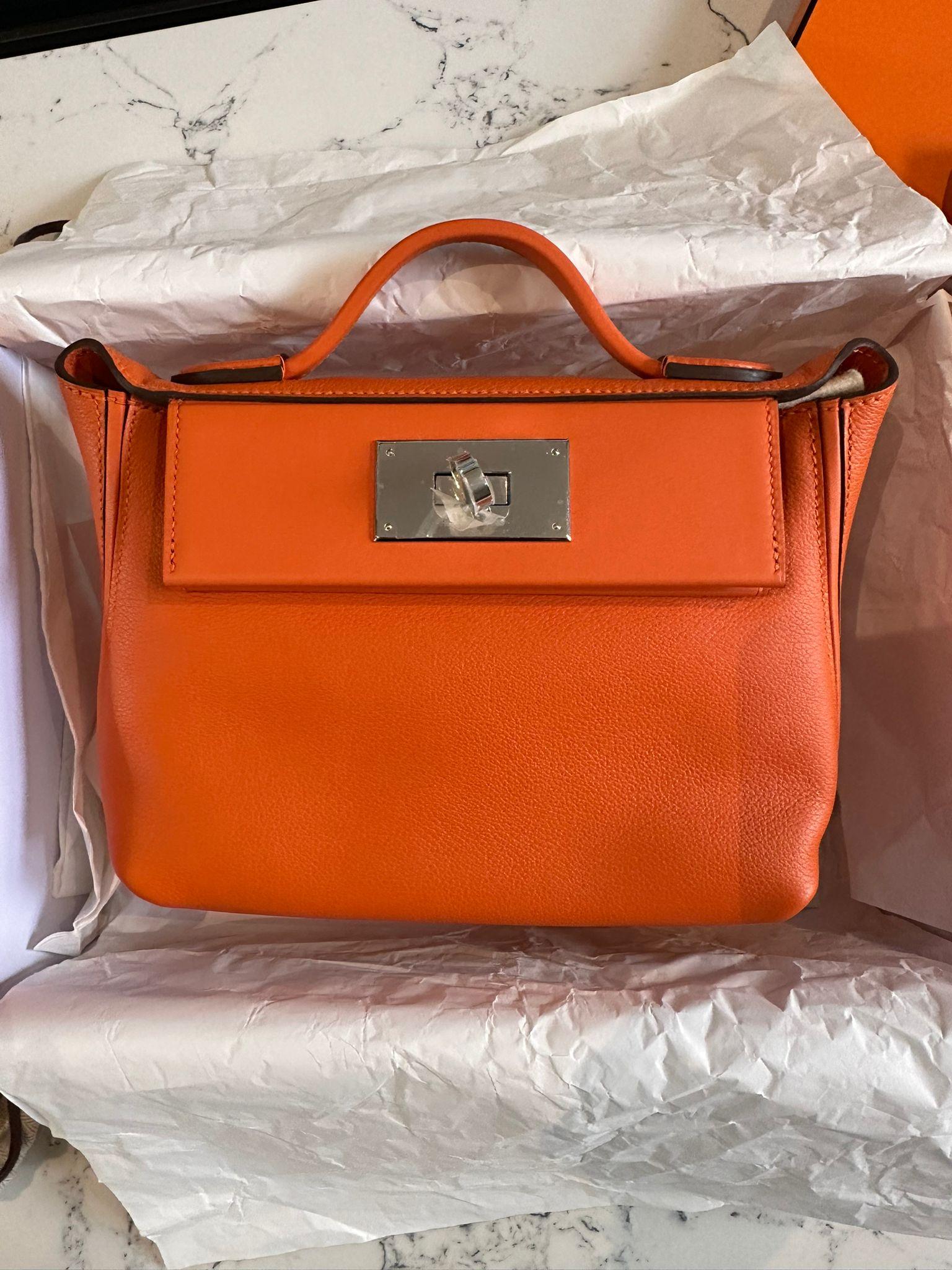 HERMÈS 24/24 - mini 21 handbag in Feu Evercolor leather with Palladium hardware. Brand new in box. B stamp 2023. Everything included. 
