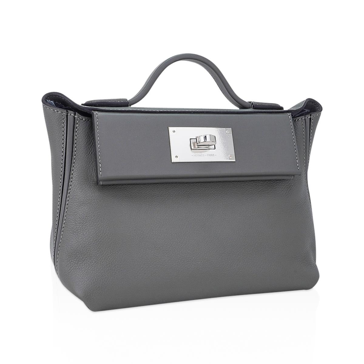 Mightychic offers an Hermes 24/24 21 mini bag featured in Gris Meyer.
Slouchy, chic as has style whether worn as a top handle, shoulder or crossbody bag,
waist bag or backpack.
Perfect chic casual to take to day to evening.
Rear has a slot pocket