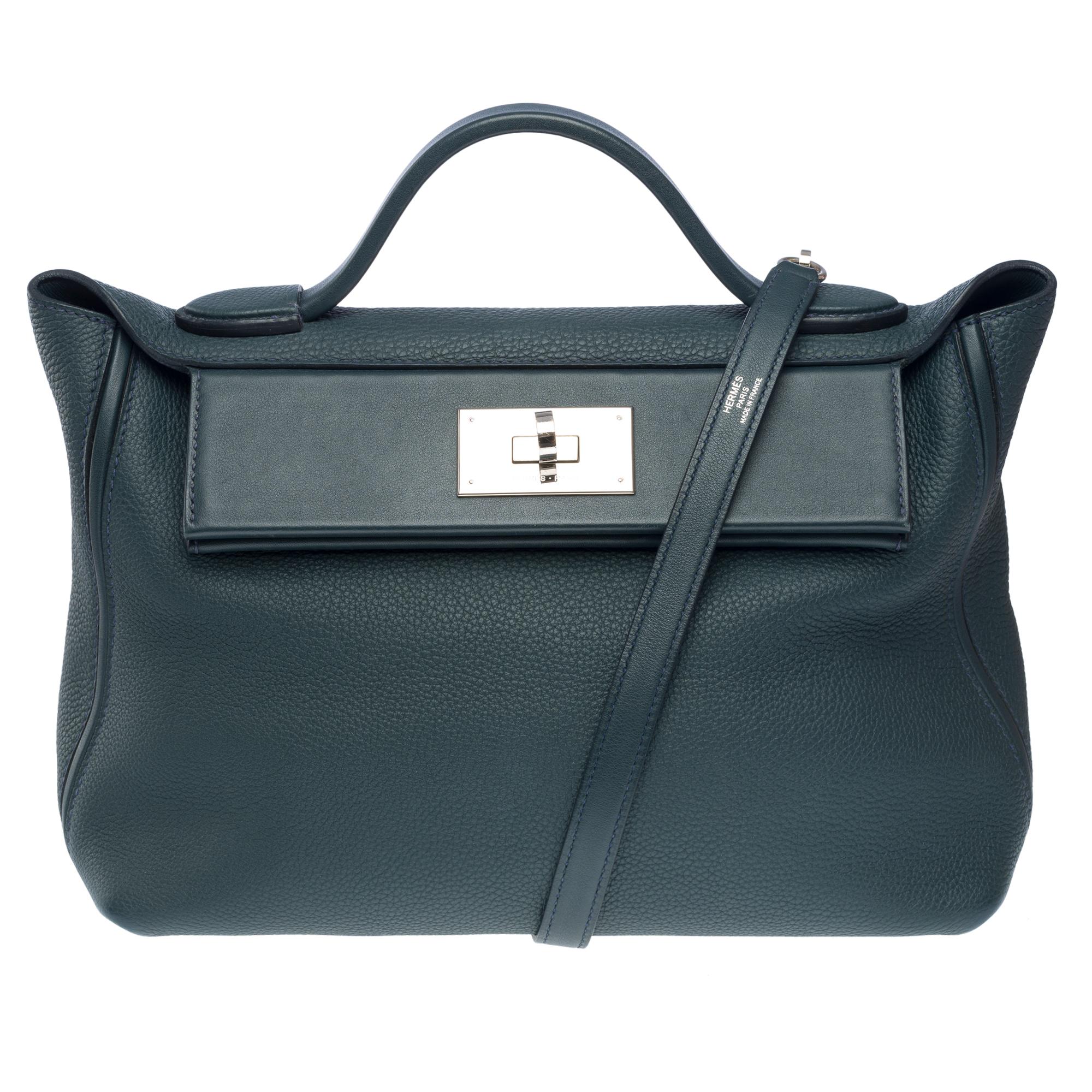 Very​ ​Chic​ ​Hermès​ ​24/24​ ​bag​ ​in​ ​Cyprès​ ​green​ ​togo​ ​leather,​ ​palladium​ ​metal​ ​trim,​ ​blue​ ​leather​ ​shoulder​ ​strap,​ ​blue​ ​leather​ ​handle​ ​allowing​ ​a​ ​hand​ ​or​ ​shoulder​ ​or​ ​shoulder​ ​strap

A​ ​closure​ ​by​