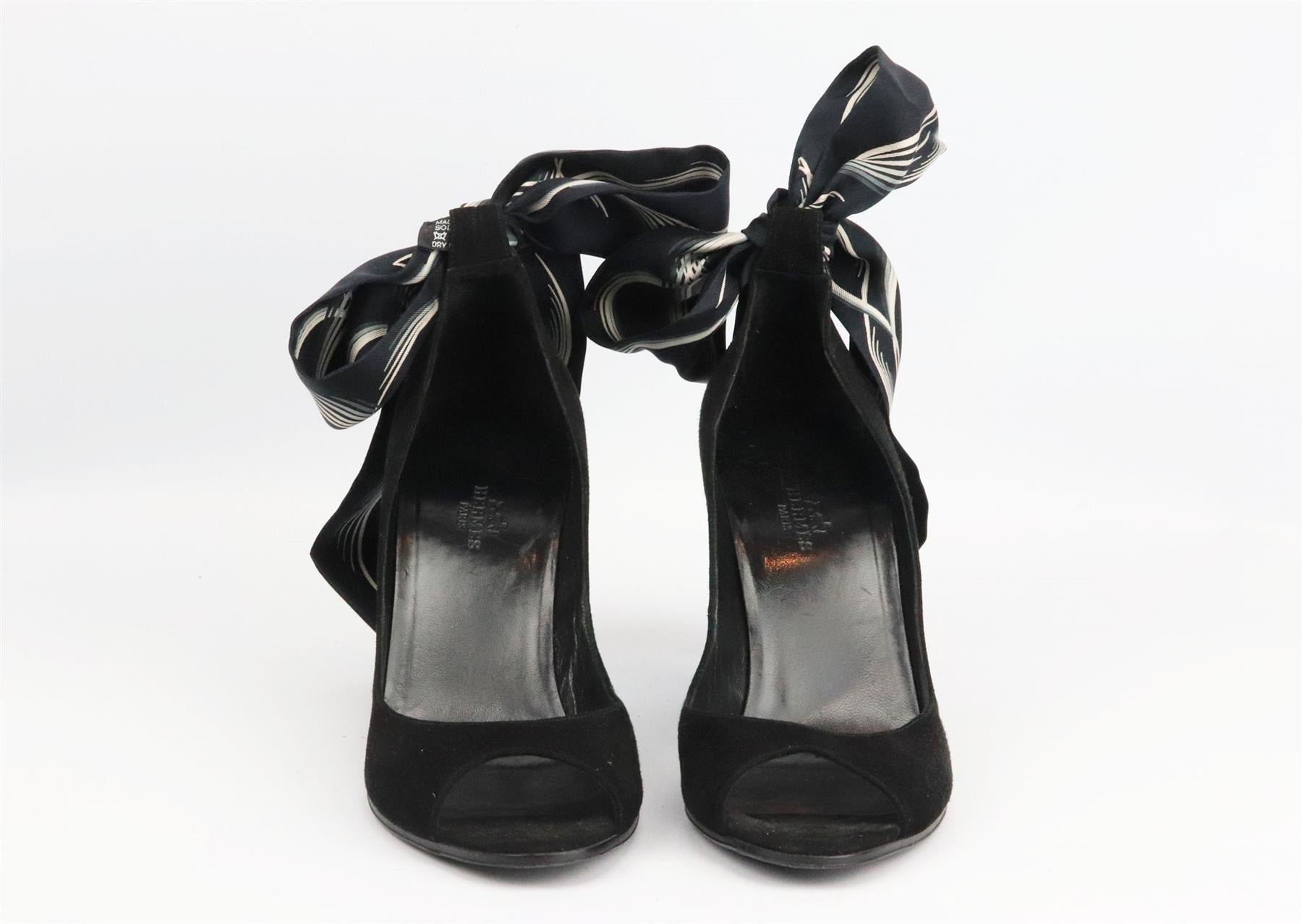 These sandals by Hermès have been made in Italy from black suede, they're set on a structured wedge heel that's balanced with the brand’s iconic silk printed twilly ankle strap with peep toe. Heel measures approximately 89 mm/ 3.5 inches. Black