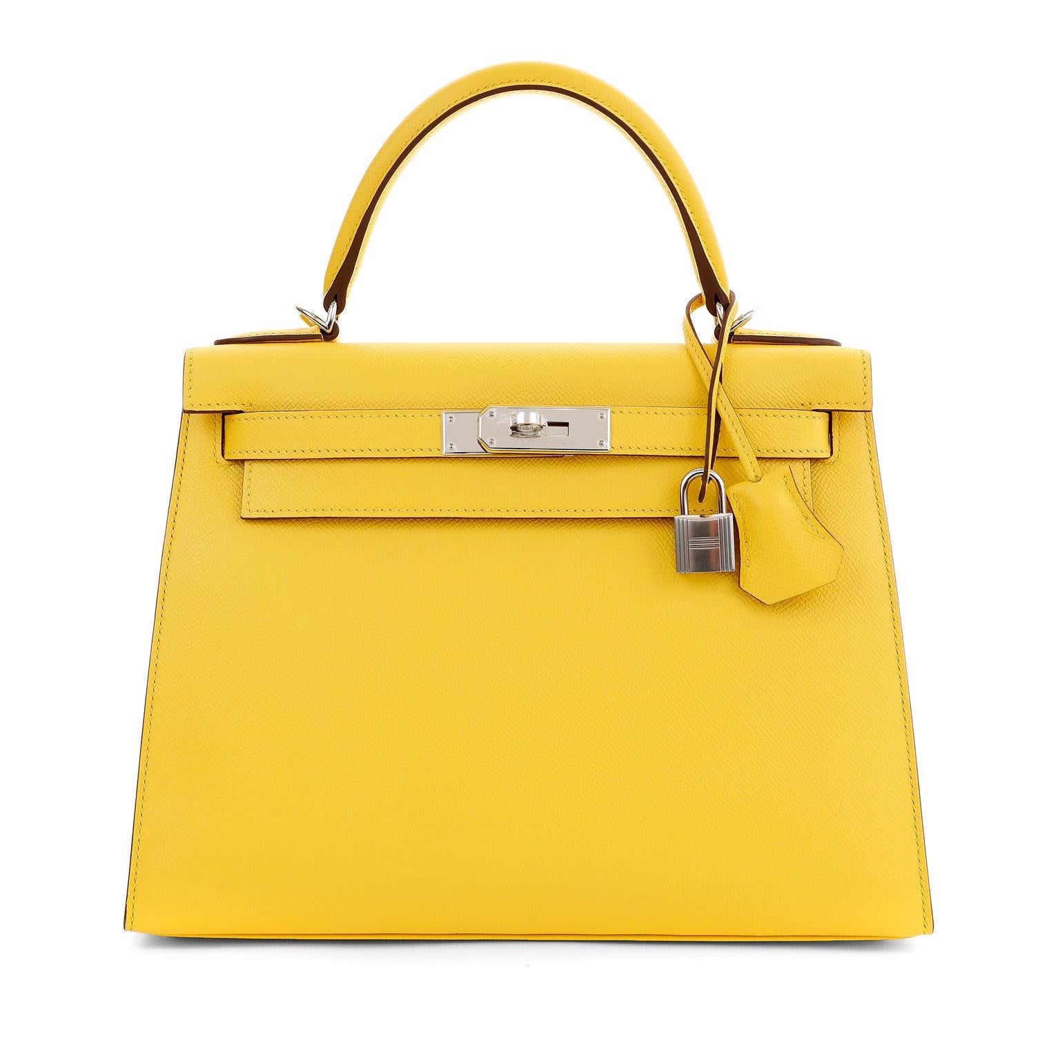 This authentic Hermès 28 cm Jaune de Naples Yellow Epsom Kelly Sellier is in pristine condition with the protective plastic intact on the hardware.   Hermès bags are considered the ultimate luxury item worldwide.  Each piece is handcrafted with