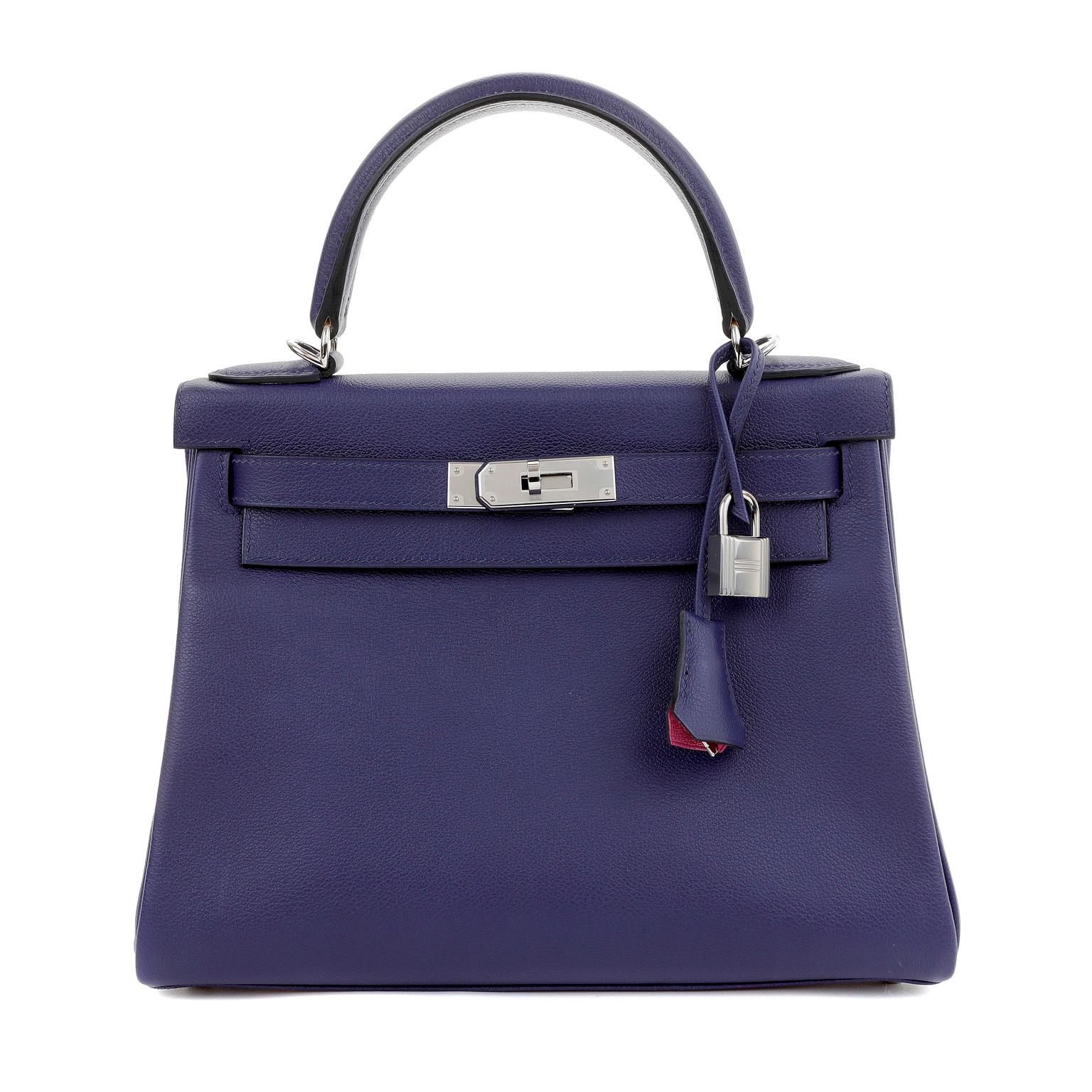 This authentic Hermès Midnight Blue Epsom 28 cm Kelly Sellier is in pristine unworn condition with the protective plastic intact on the hardware.  Hermès bags are considered the ultimate luxury item worldwide.  Each piece is handcrafted with