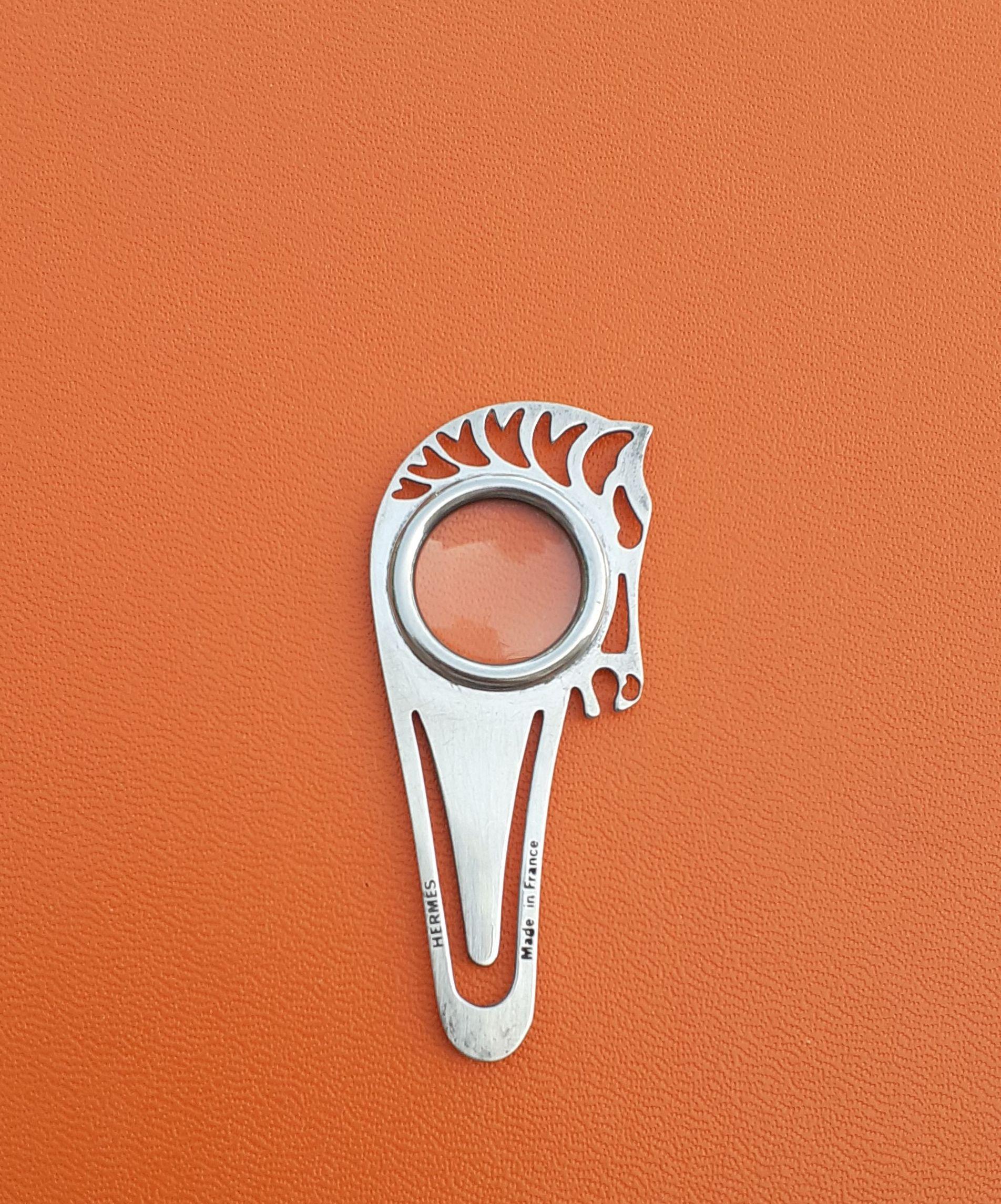 Rare Authentic Hermès 3 functions item:

- paperclip
- magnifying glass
- bookmark

Works on both sides

Shaped as horse head

Made of Silvered metal (not precious)

