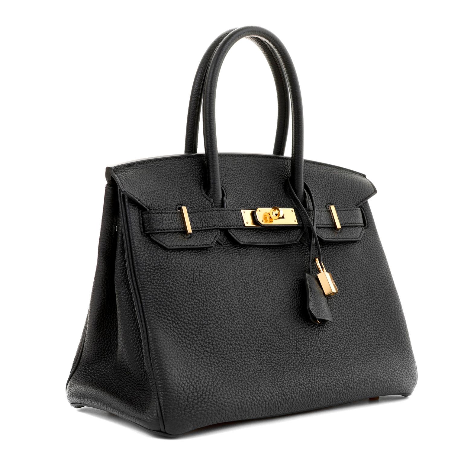 This authentic Hermès Black Togo Leather 30 cm Birkin Bag is in pristine unworn condition.  The protective plastic remains intact on  the hardware.

Togo is scratch resistant calf leather; it is textured with a wonderful grainy appearance.  Togo is