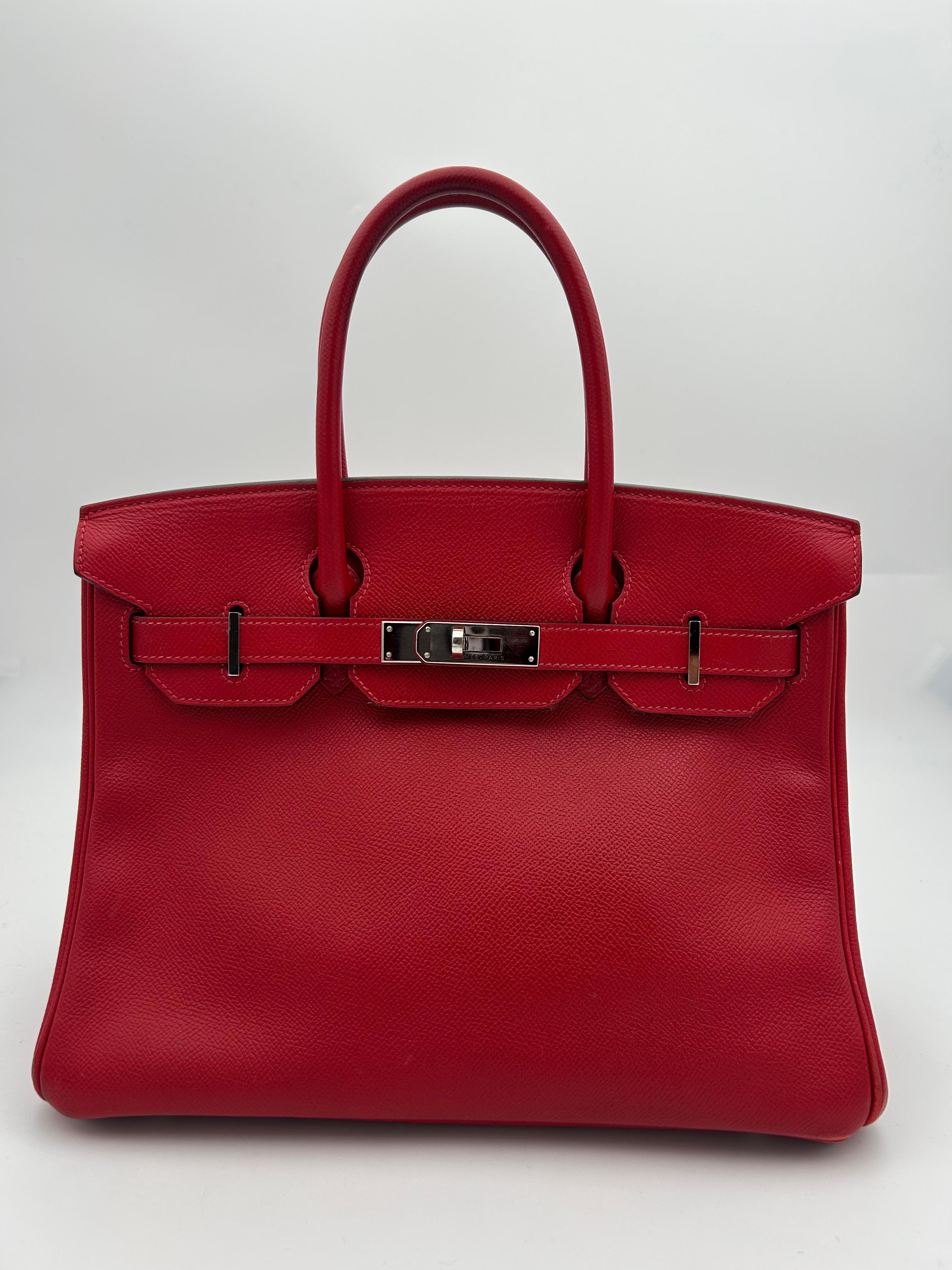 Hermès 30 Rouge Garance Epsom Leather Birkin. This classic handbag has beautiful platinum hardware and rich Epsom leather, which is renowned for its strength and form retention.  Its production year is indicated by the 