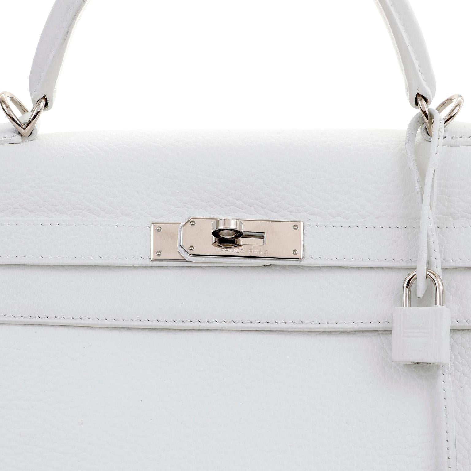 This authentic Hermès 32 cm White Togo Leather Kelly Bag is in pristine condition. Hermès bags are considered the ultimate luxury item worldwide.  Each piece is handcrafted with waitlists that can exceed a year or more. The streamlined and demure