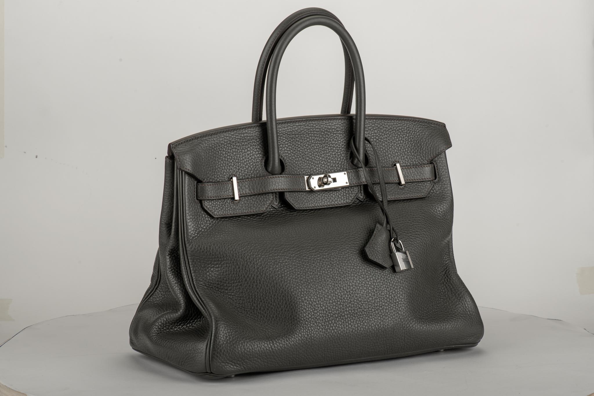 Hermès 35cm Birkin in gris elephant taurillon clemence leather with palladium hardware. Date stamp T for 2015. Comes with clochette, tirette, two locks, keys, dust cover.