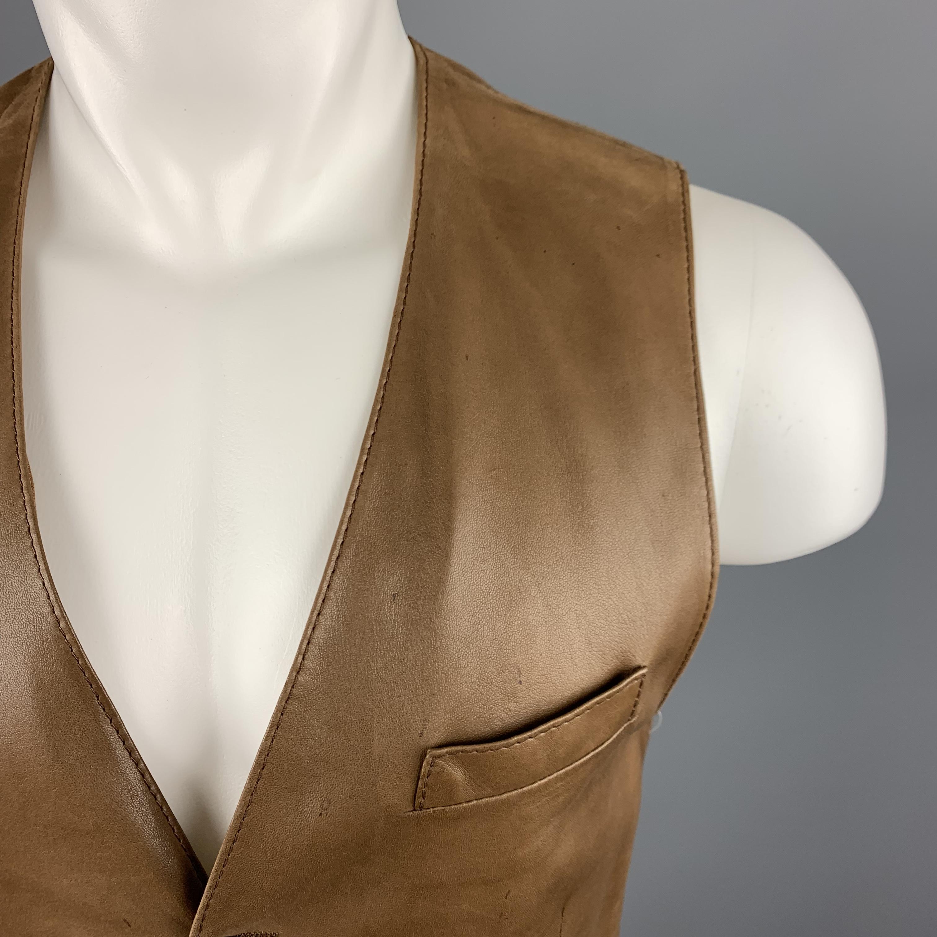 SPORTS HERMES by HERMES Vest comes in a solid tan leather, featuring a V-neck, slit pockets, five silver tone metal buttons at closure and a back belt. Wear, with small spots at front. Made in Belgium.
 
Very Good Pre-Owned Condition.
Marked: No